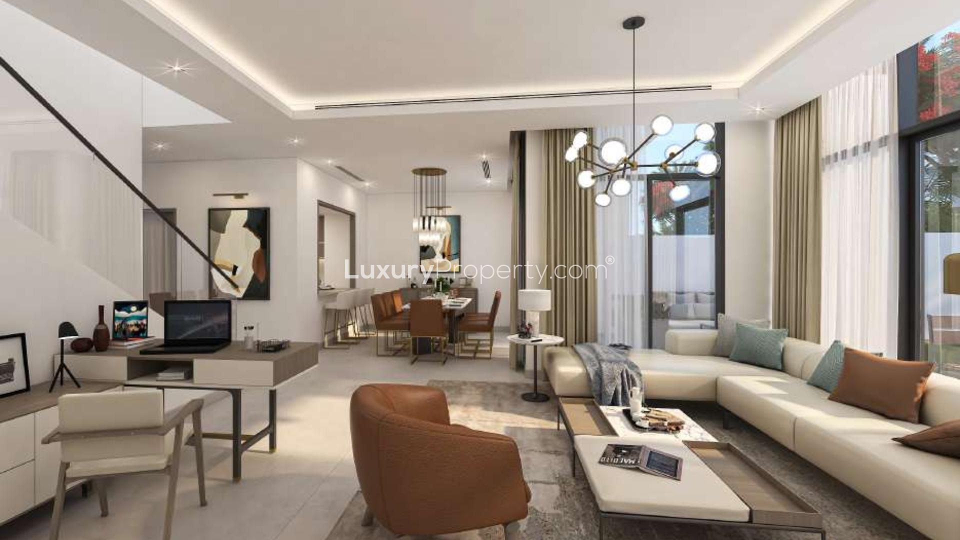 Contemporary townhouse exterior in Murooj Al Furjan, featuring lush garden and walking path