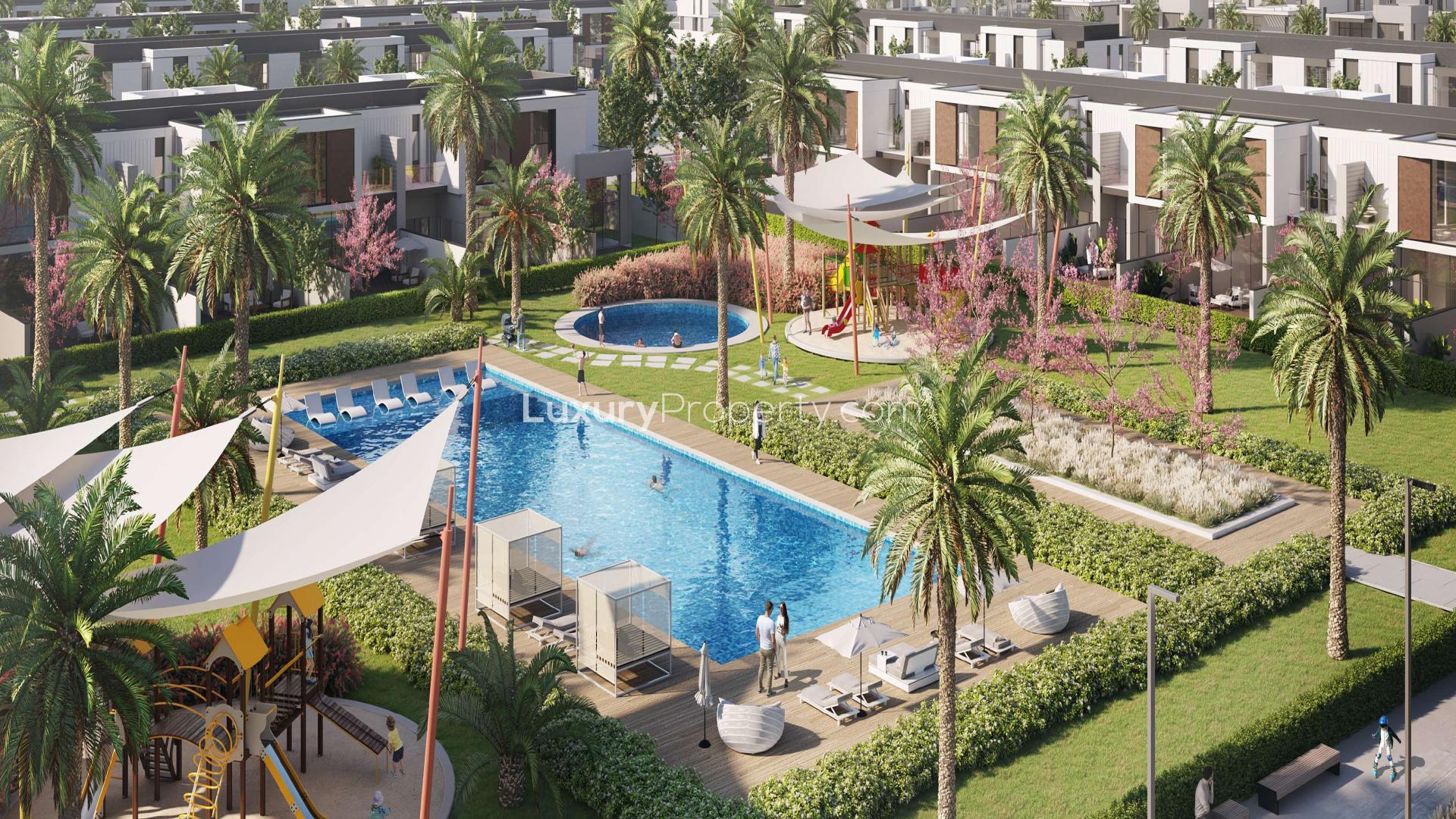 Modern townhouse exterior in Murooj Al Furjan with carport, surrounded by greenery