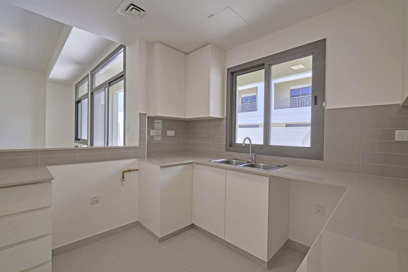 Impeccable 3-bedroom townhouse exterior in Naseem, Town Square for sale. Spacious driveway and garden