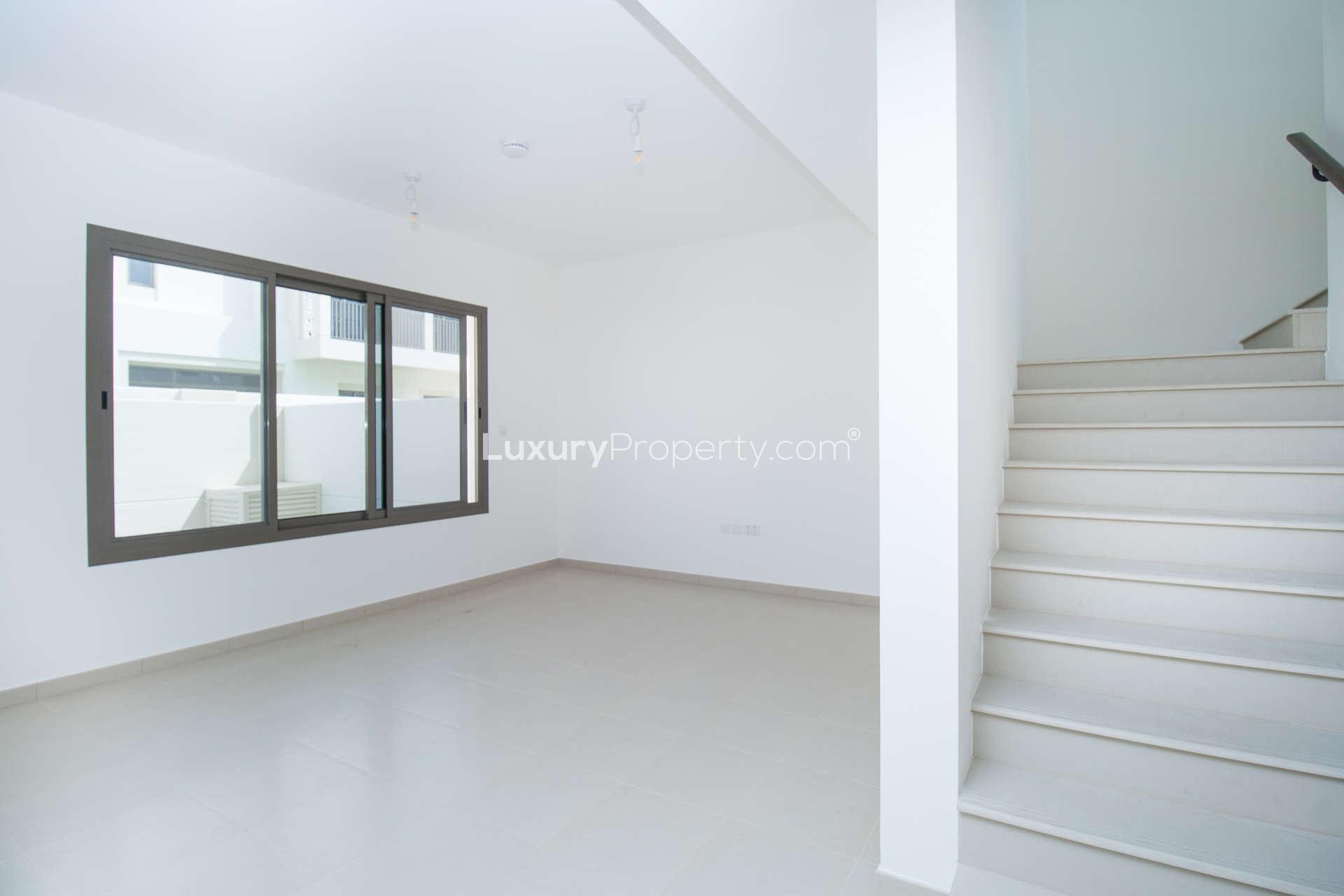 Modern living area in 3-bedroom townhouse, Noor Town Square Dubai, with sliding doors and stairs