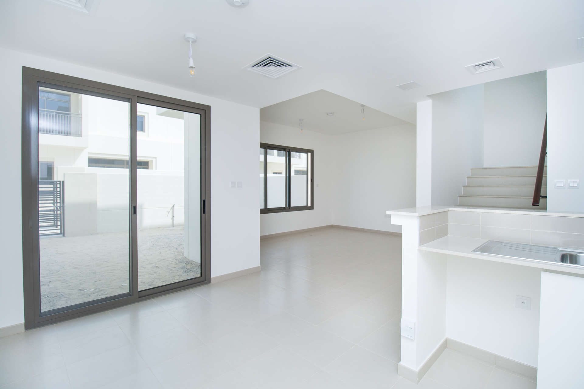 Modern kitchen and staircase in 3-bedroom townhouse, Noor, Town Square Dubai