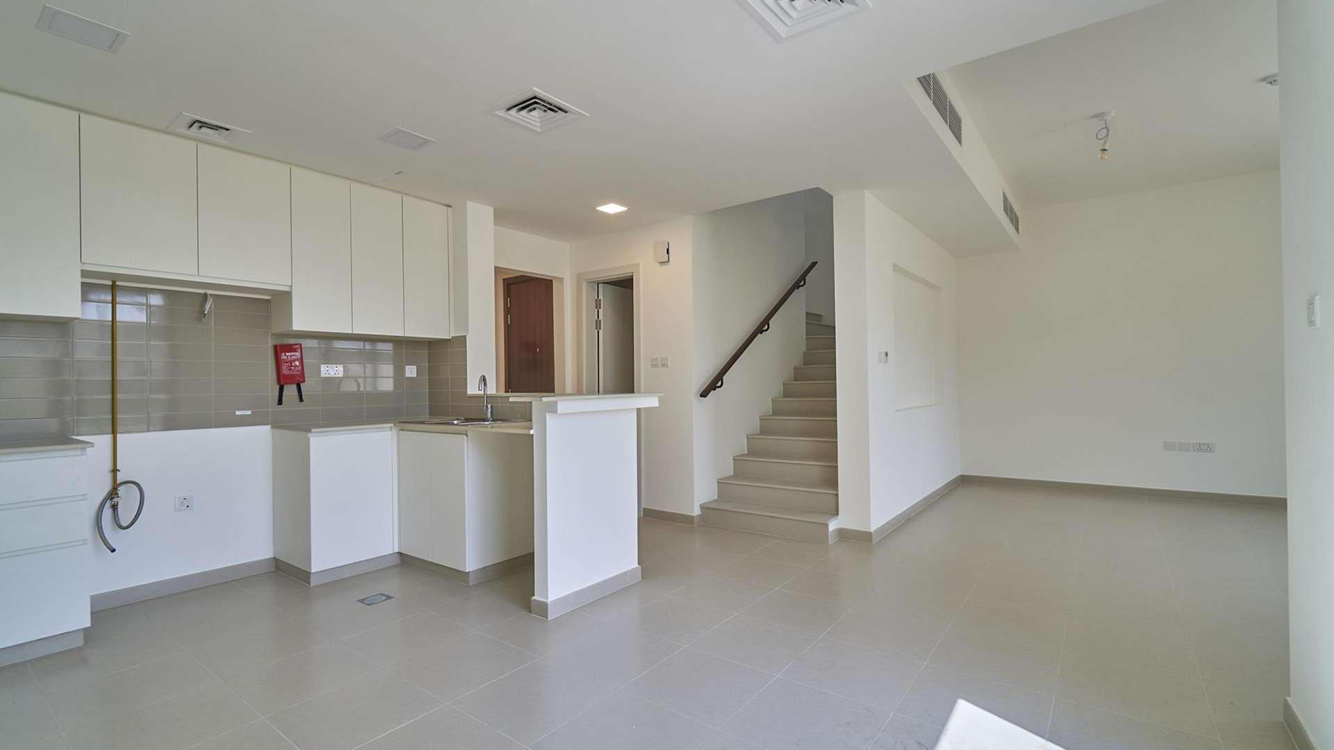 Modern kitchen and living area in Noor Townhouse, Town Square, Dubai