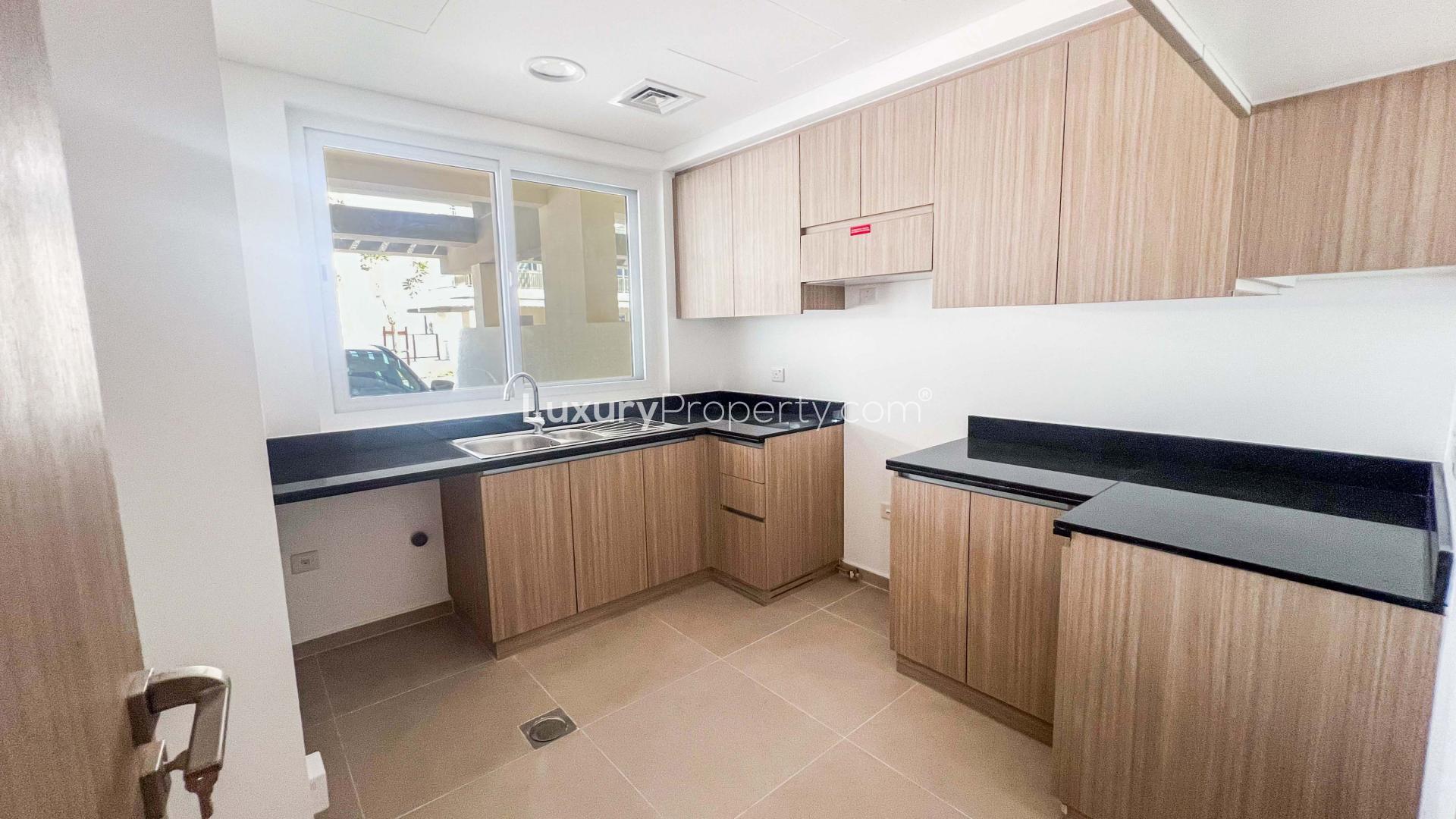 Bright living room with large windows in Victoria 2 townhouse, Damac Hills 2