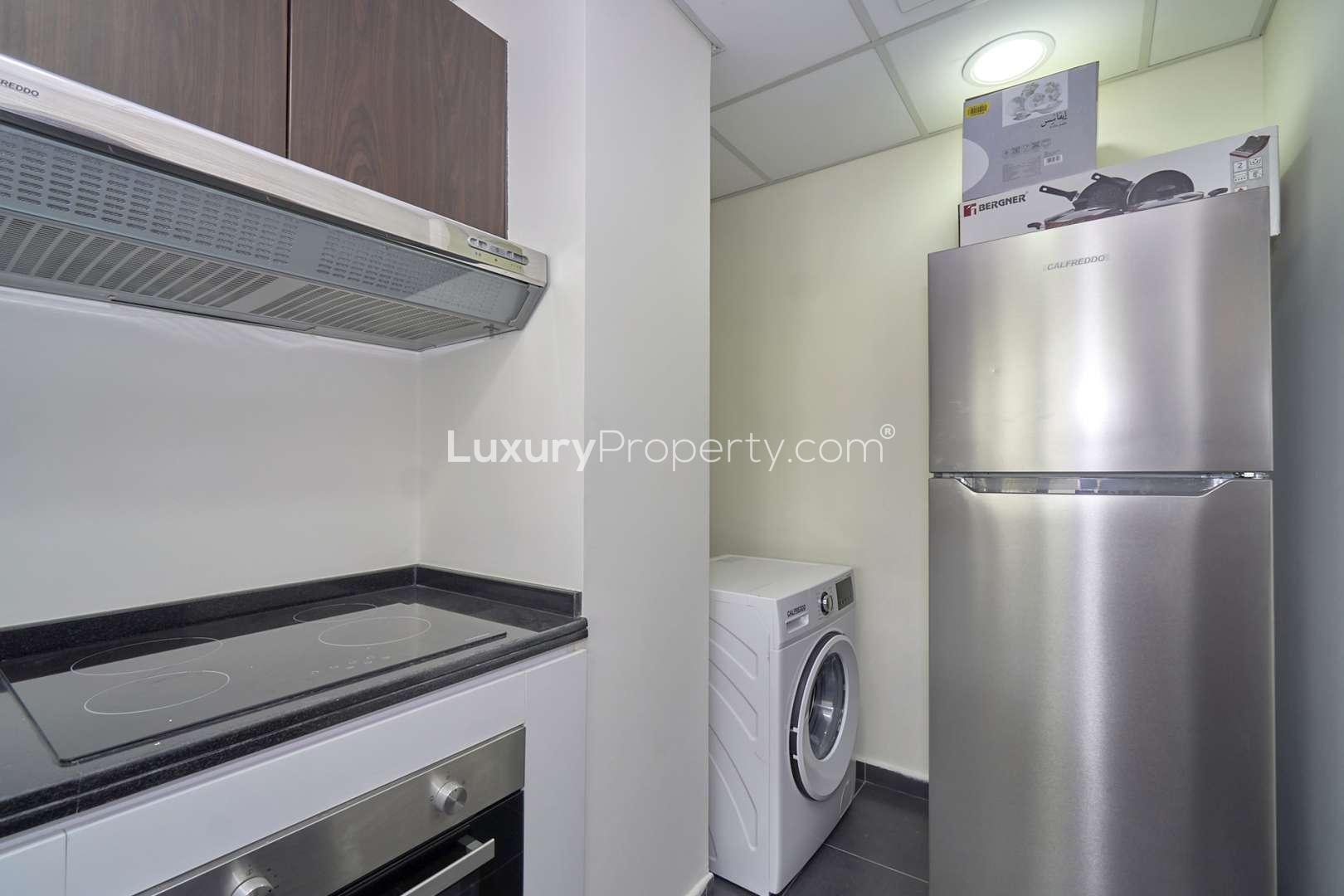 Modern kitchen with appliances in fully furnished townhouse, Pacifica, Akoya by DAMAC Hills 2