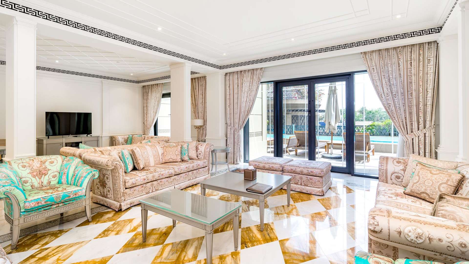 Luxurious living room in Palazzo Versace Villa, Culture Village, with elegant decor and pool view