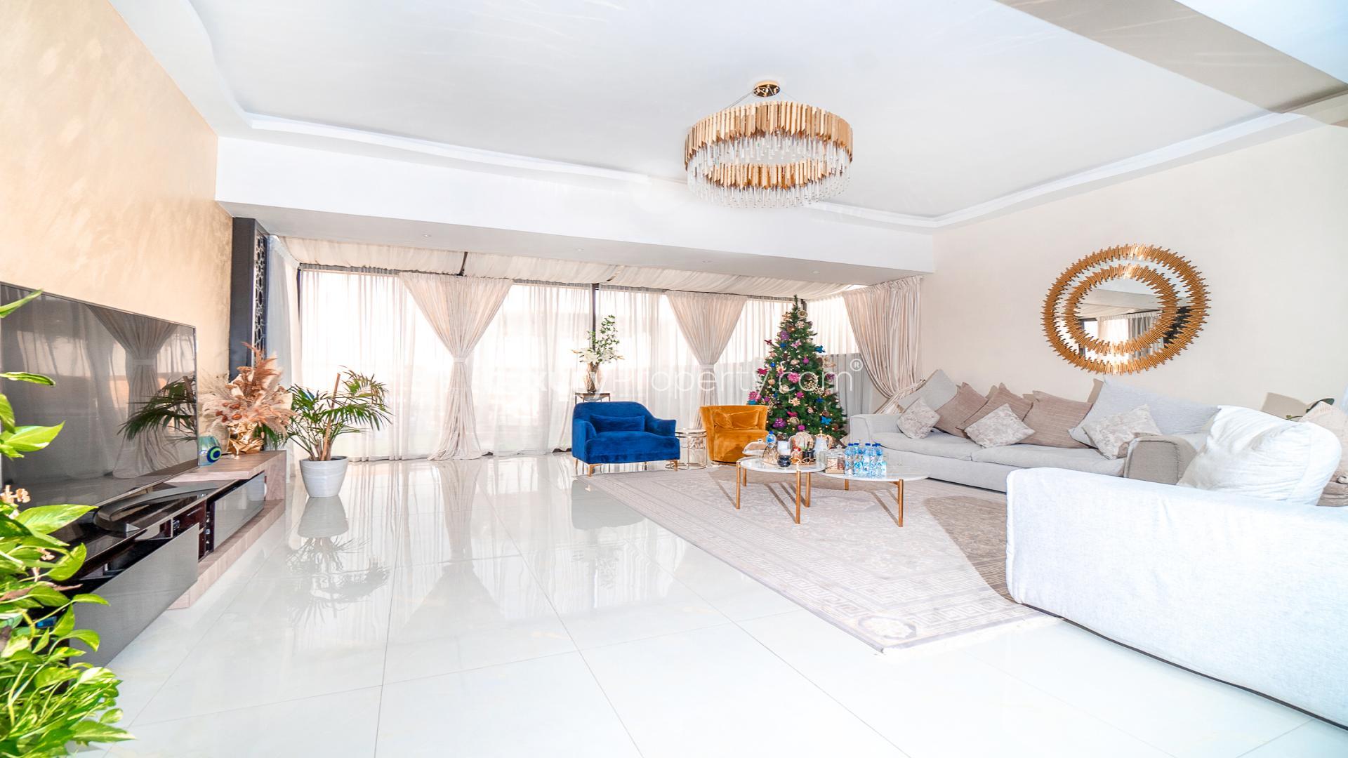 Upgraded 3-bedroom townhouse exterior in Queens Meadow, Damac Hills, with modern THK layout