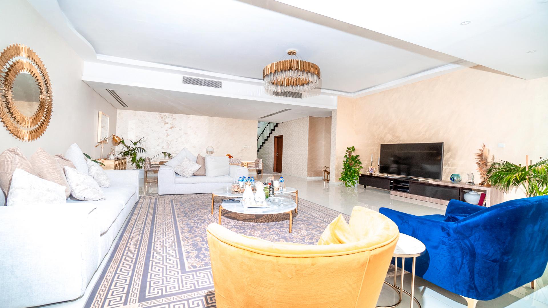 Outdoor patio with seating and pergola in Damac Hills townhouse, Queens Meadow