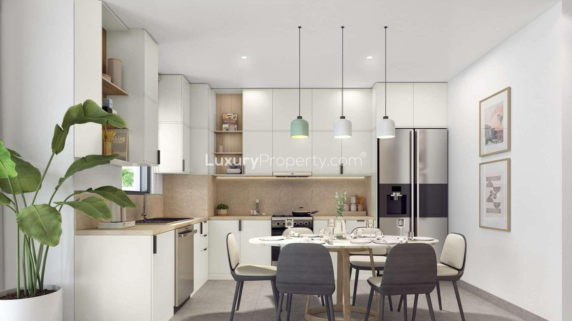 Modern kitchen in 3-bedroom townhouse, Arabian Ranches 3, featuring dining area and sleek design