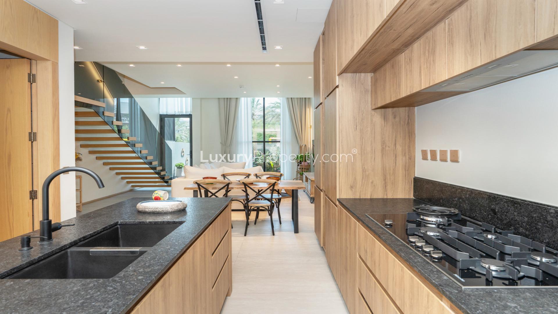 Elegant living room in The Autograph X townhouse, Jumeirah Village Circle, featuring modern staircase