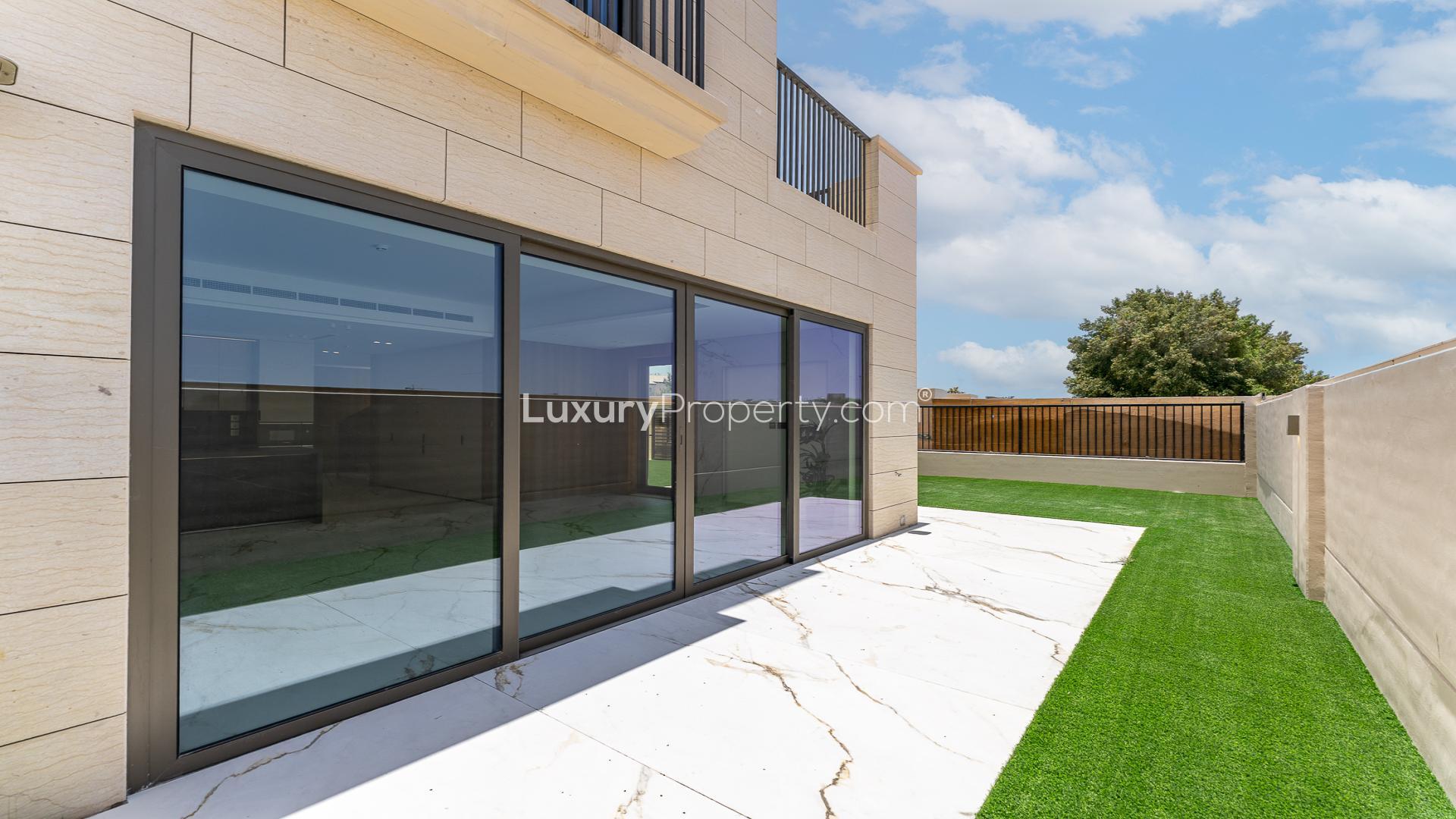 Spacious marble-floored living area with garden view in Jumeirah Golf Estates townhouse