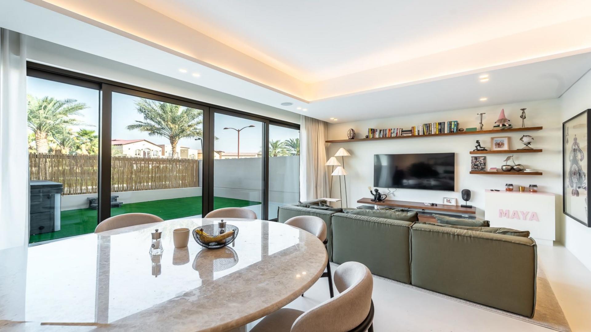 Modern living and kitchen area in Jumeirah Golf Estates townhouse, Jasmine Lane, for sale