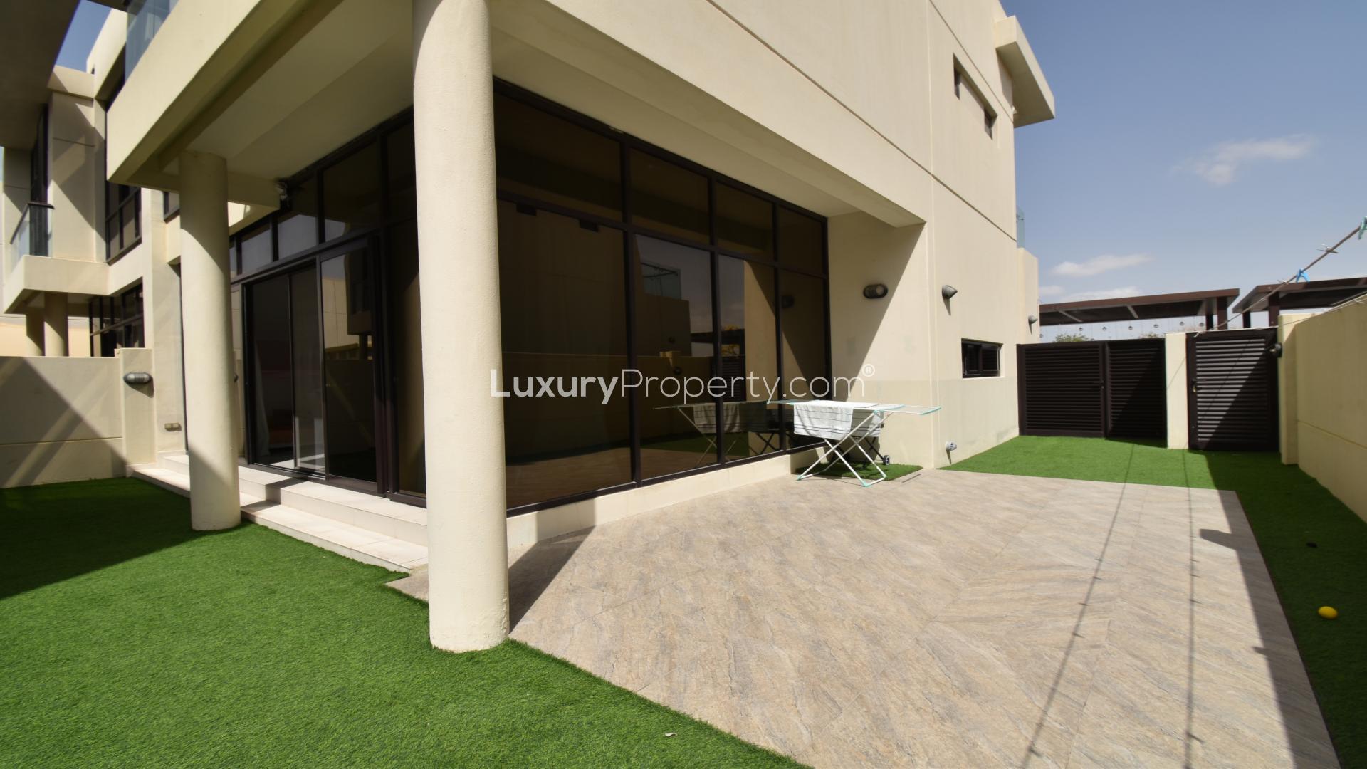 Bright living room with large windows in Damac Hills townhouse for sale