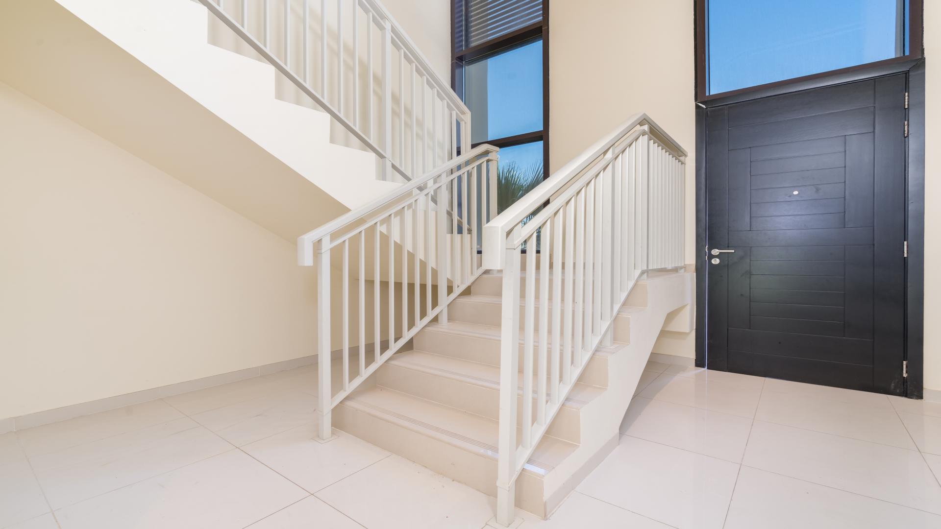 Corner plot townhouse patio with artificial grass in Damac Hills, Topanga community