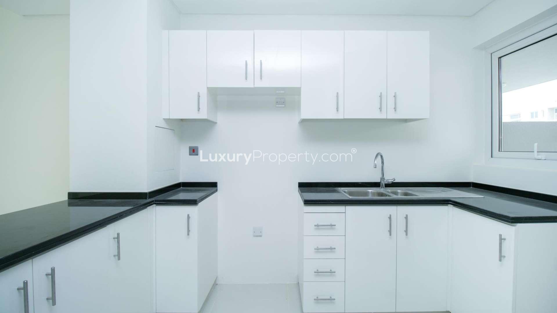 Luxury 3-bedroom townhouse exterior in Avencia, Damac Hills 2, with landscaped garden view