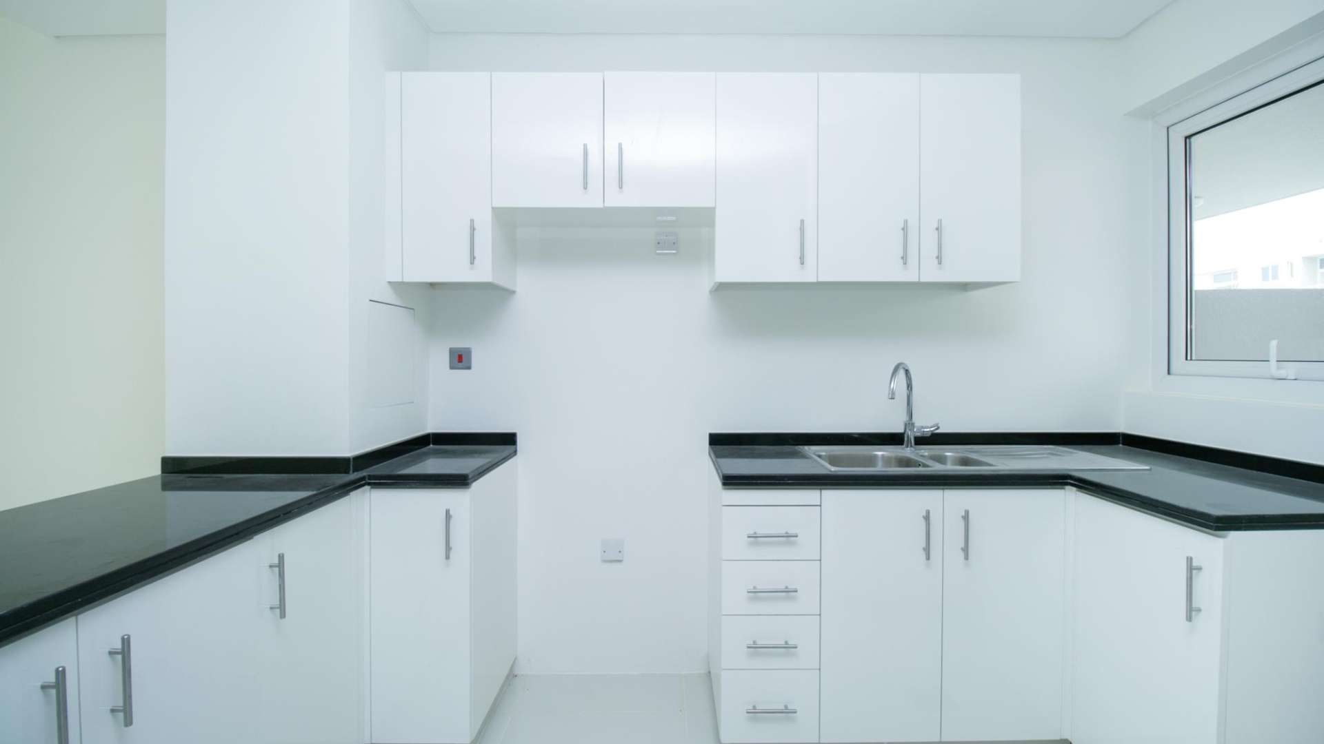 Luxury 3-bedroom townhouse exterior in Avencia, Damac Hills 2, with landscaped garden view