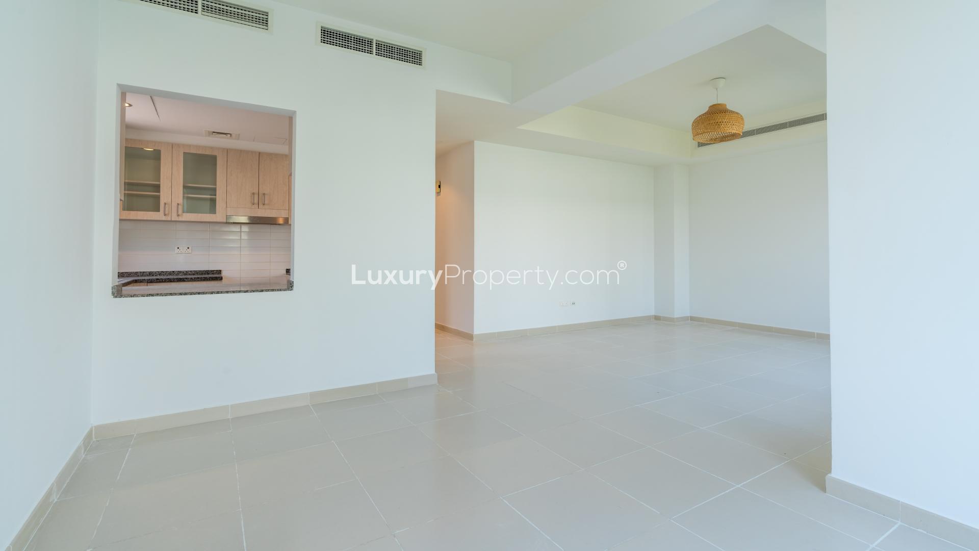 Bright living area in 3-bedroom villa, Mira Oasis, Reem Community, with large windows and garden view