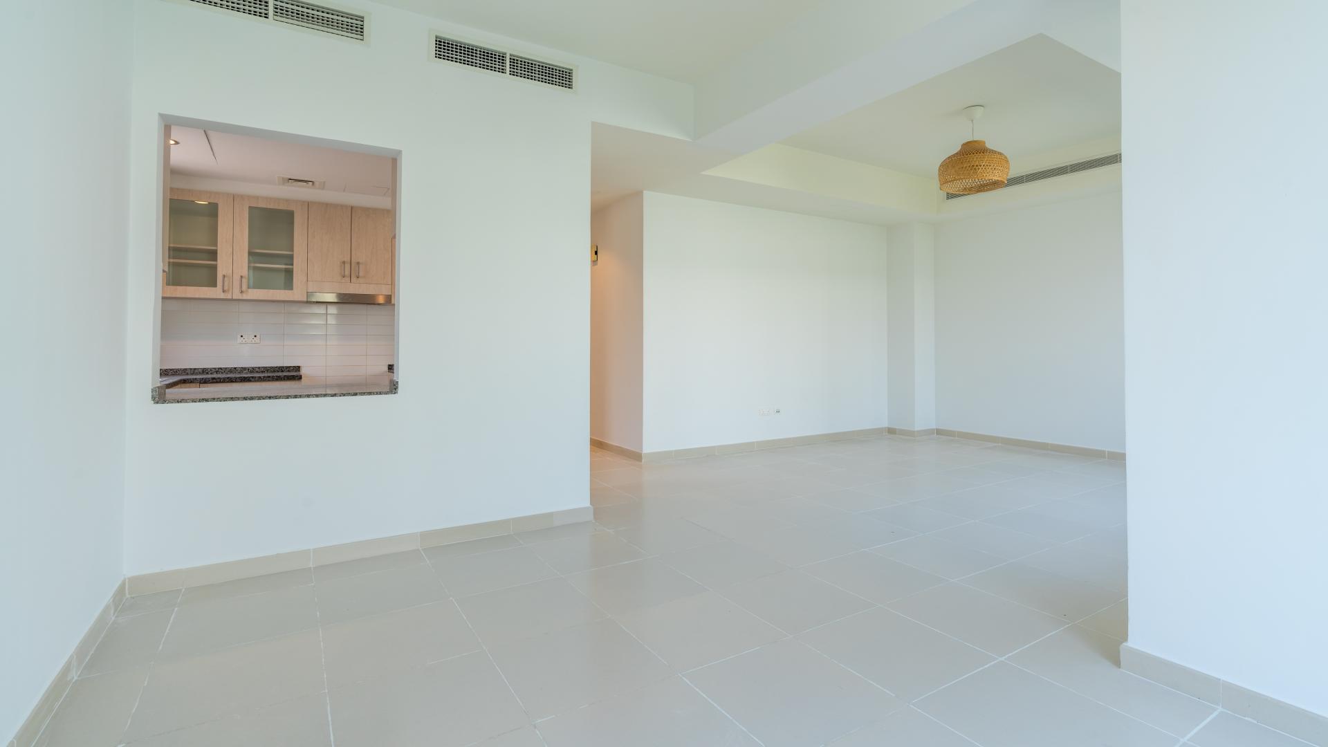 Bright living area in 3-bedroom villa, Mira Oasis, Reem Community, with large windows and garden view