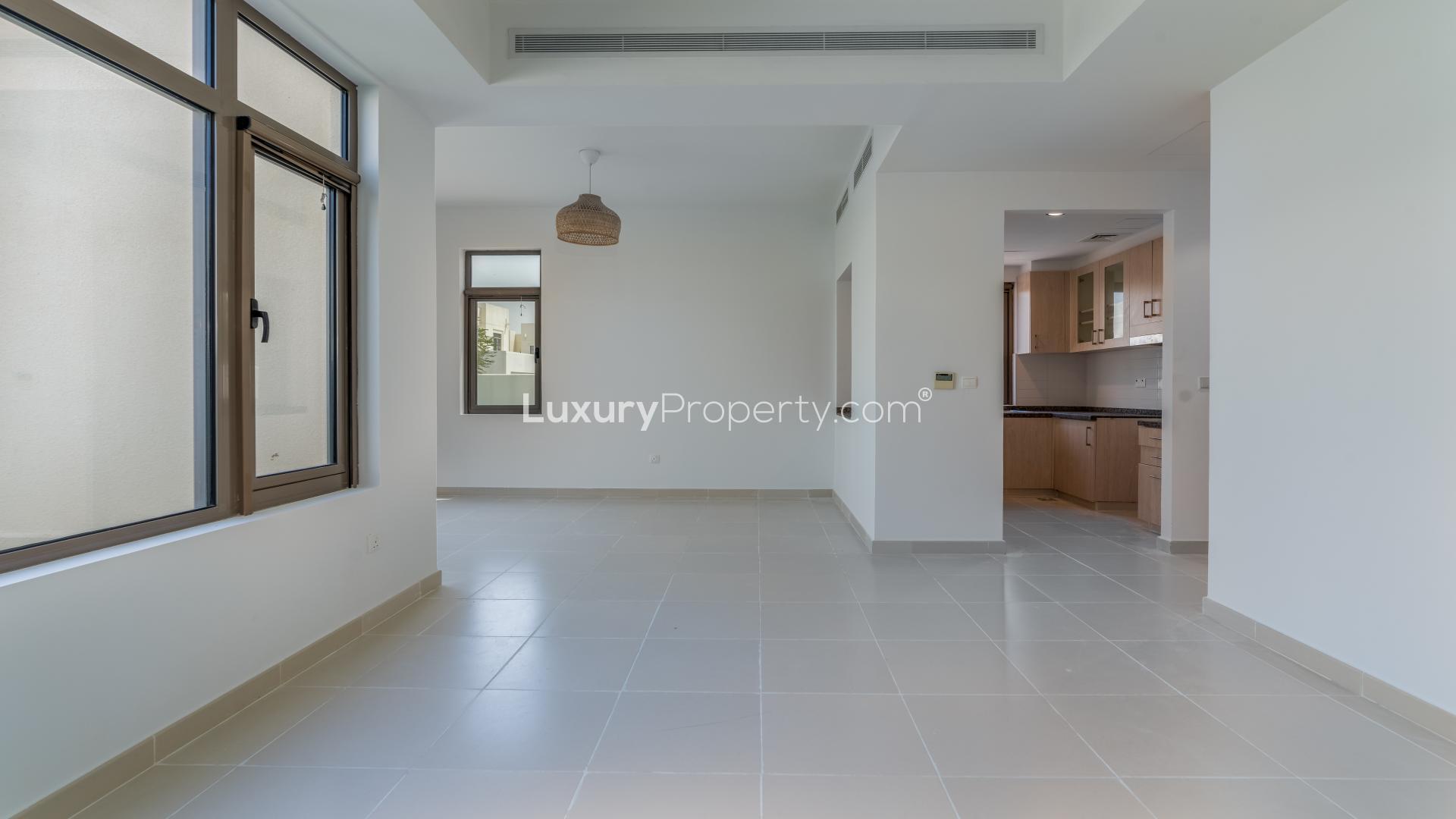 Spacious living area in 3-bedroom villa, Mira Oasis, Reem Community, featuring modern kitchen view