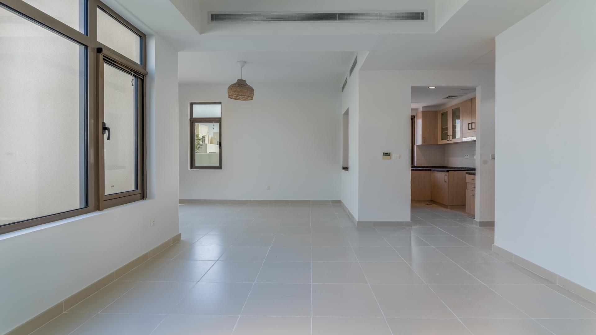 Spacious living area in 3-bedroom villa, Mira Oasis, Reem Community, featuring modern kitchen view