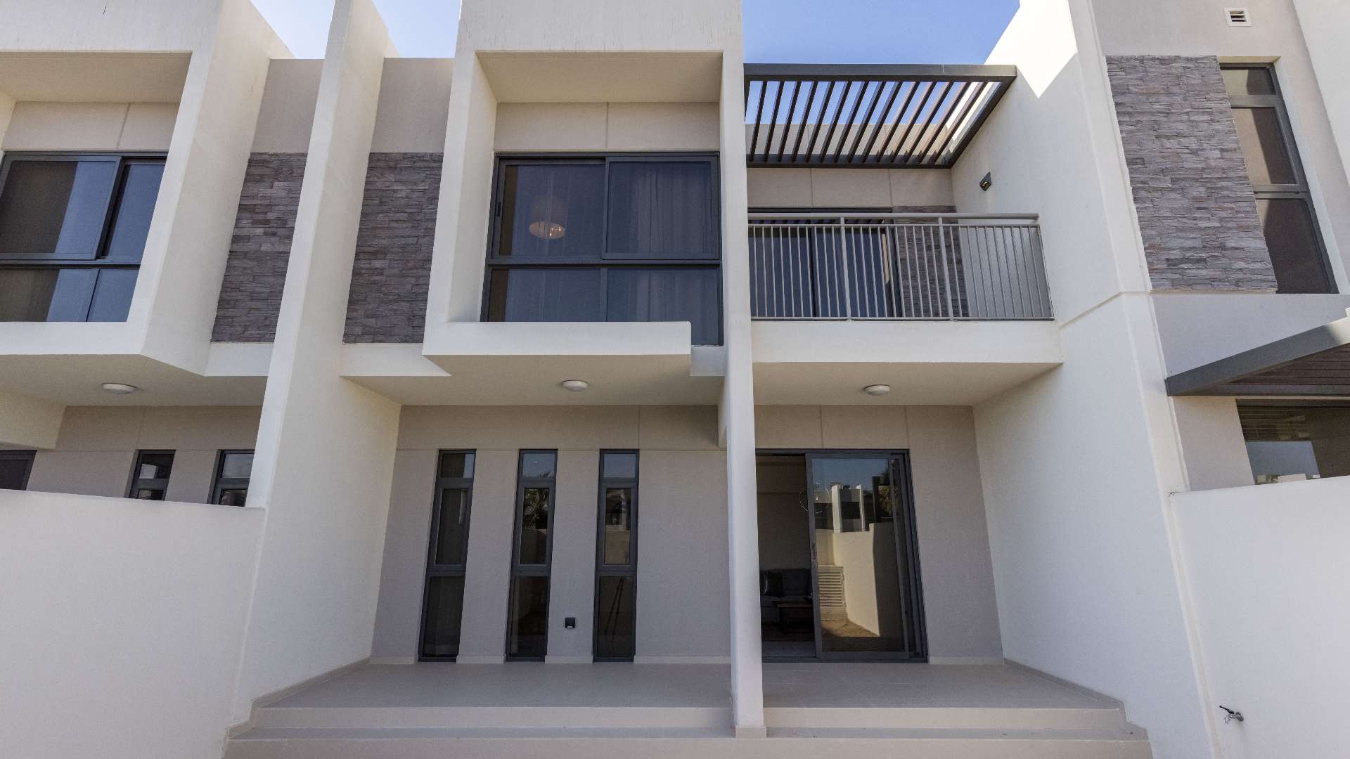Modern staircase and hallway in Zinnia townhouse, Damac Hills 2, showcasing spacious interior