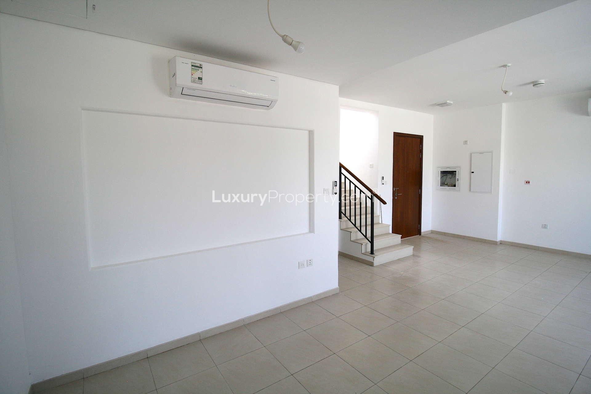 Bright living area in 3-bedroom Zahra Townhouse, Town Square, with garden view