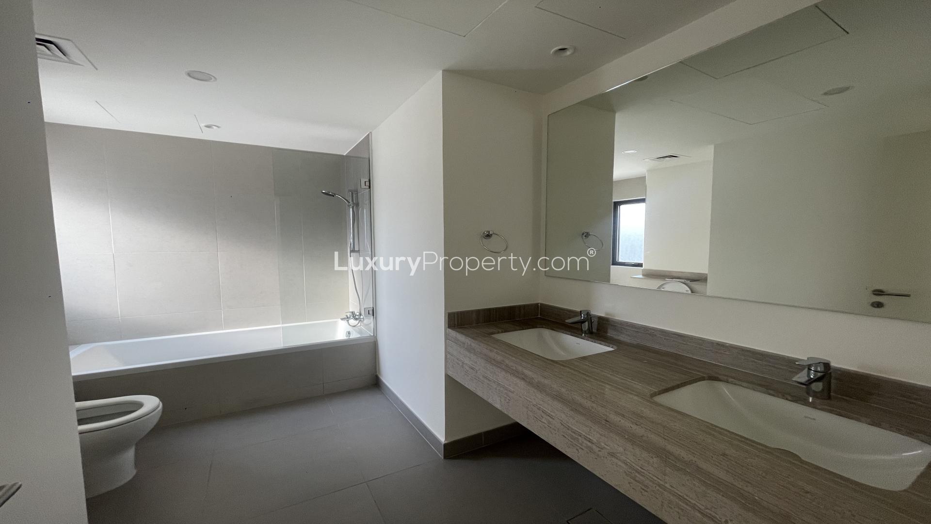 Modern bathroom in 3-bedroom villa, Dubai Hills Estate, featuring double sinks and glass shower