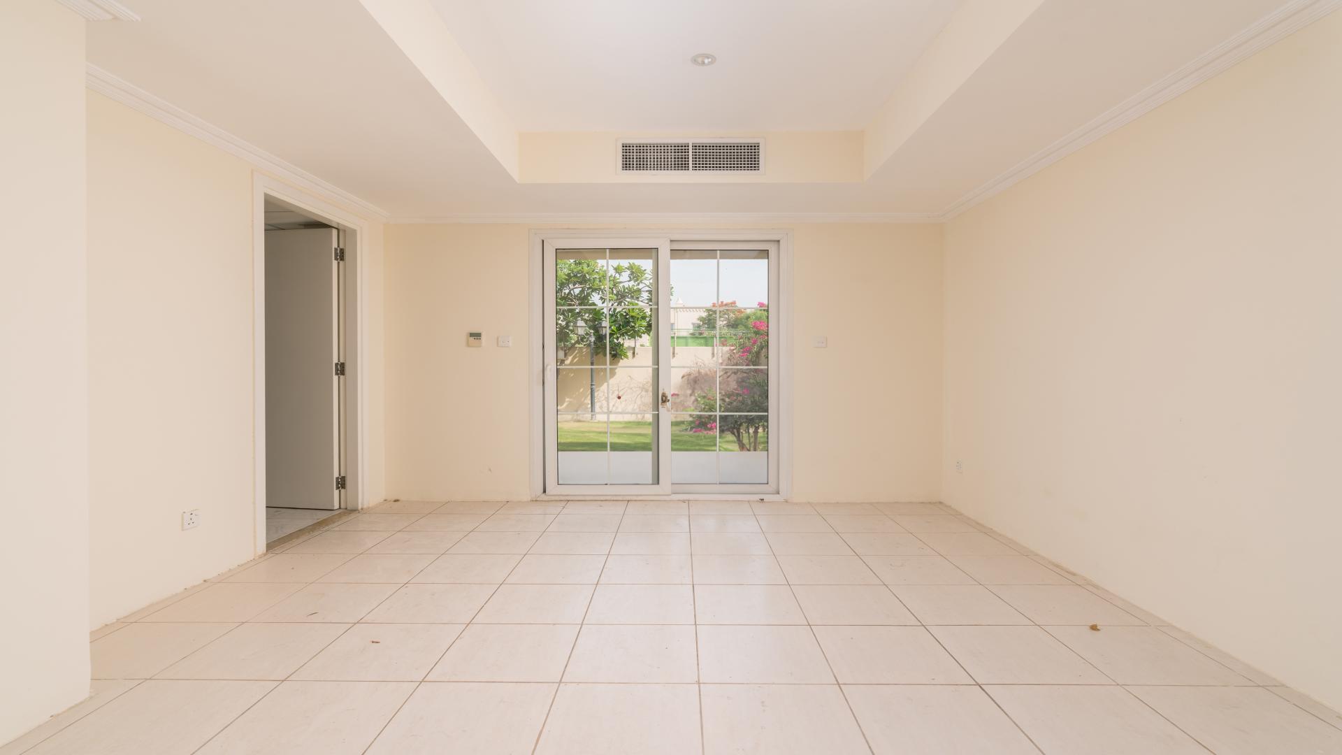 Spacious 2-bedroom villa exterior in Springs 4, Emirates Living, with driveway and car