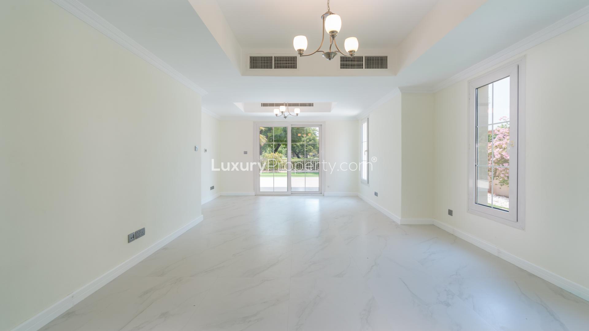 Spacious Emirates Living villa garden with lush greenery and serene lake view in The Springs