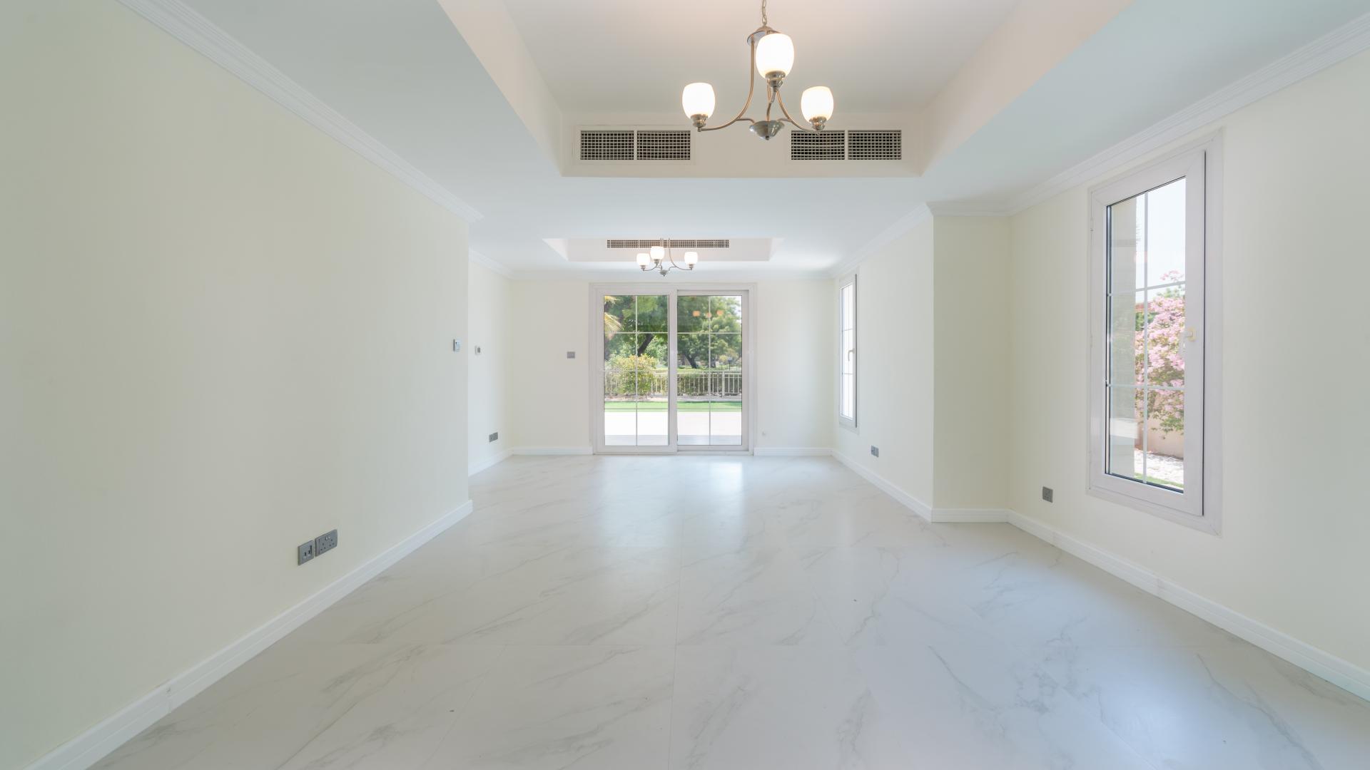 Spacious Emirates Living villa garden with lush greenery and serene lake view in The Springs