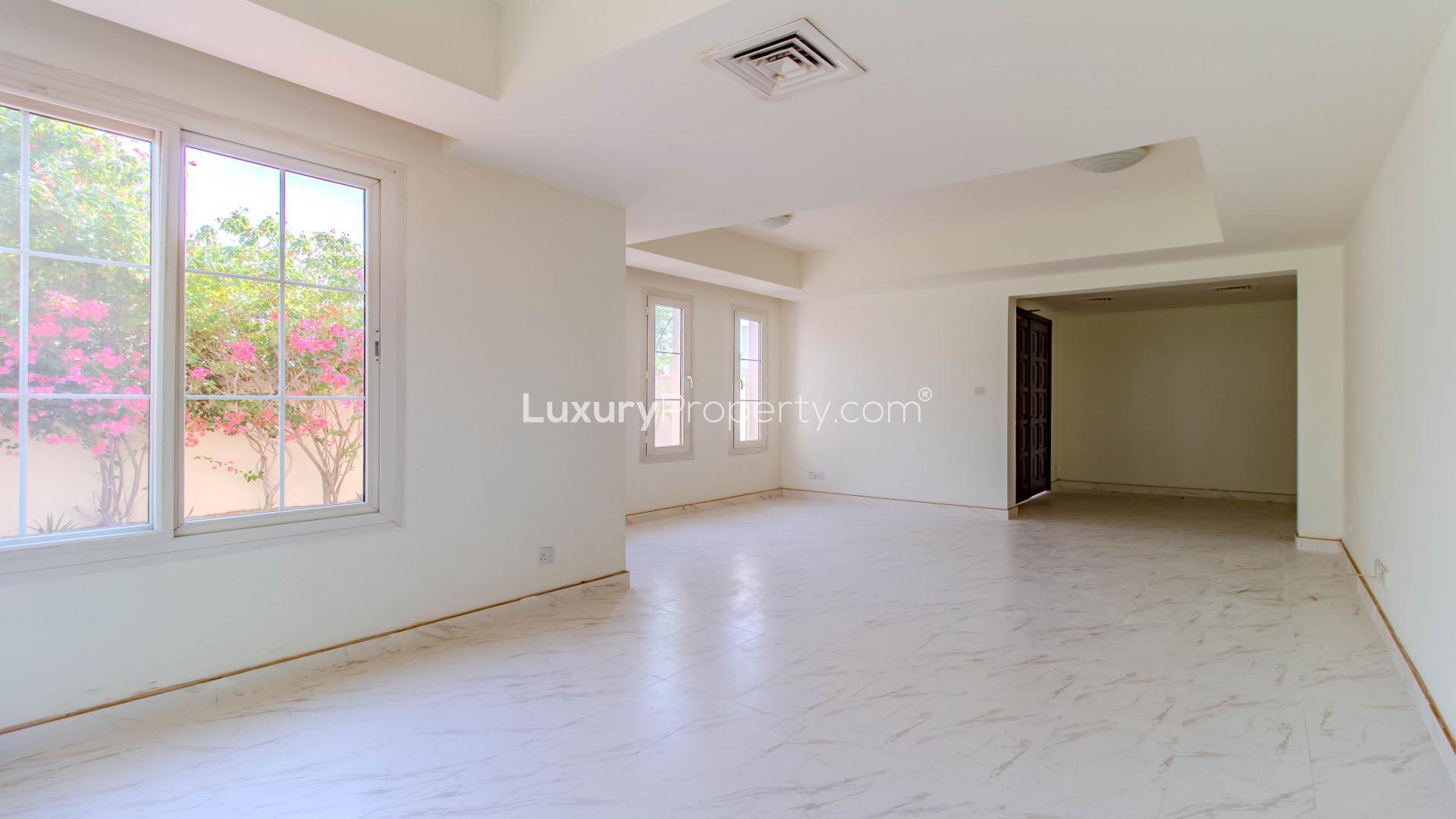 Bright living room in Springs 3 villa with garden view, ideal for families