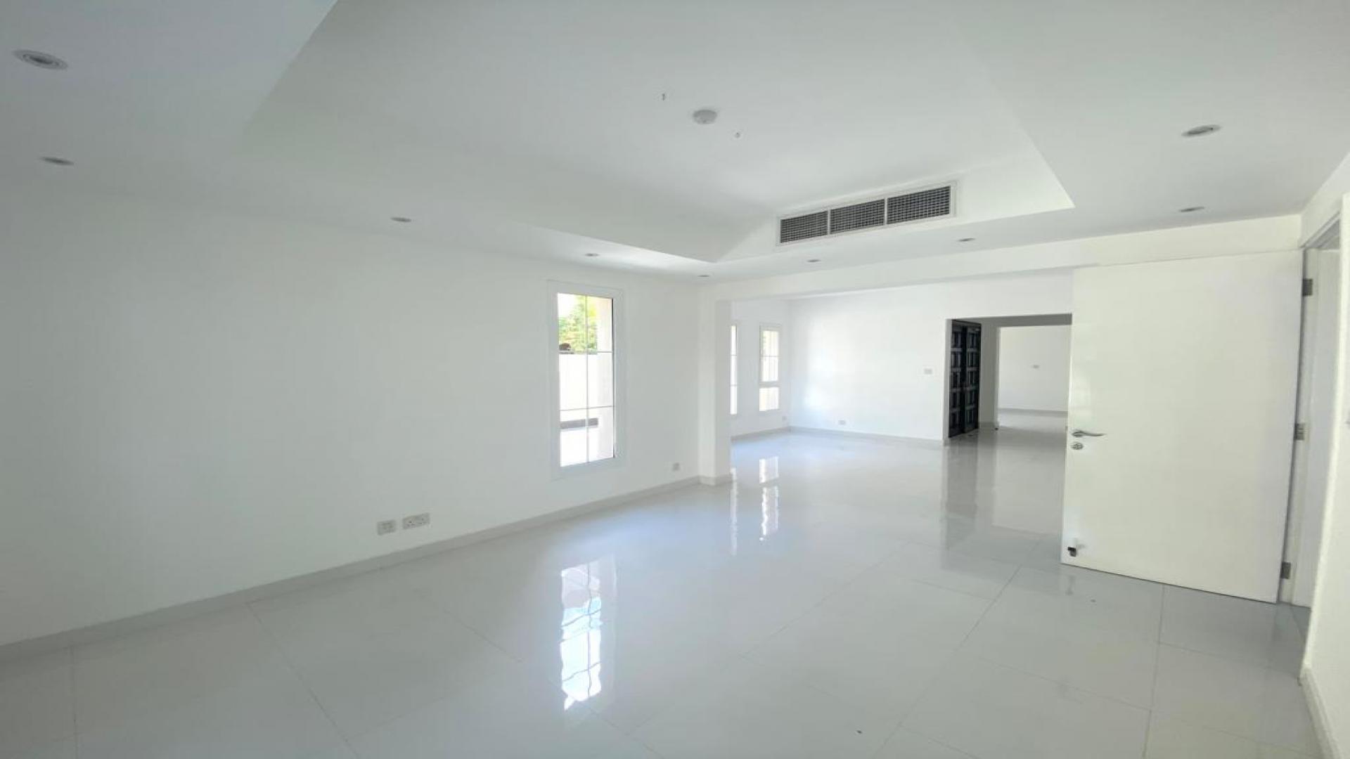 Bright living area in Springs 15 villa for rent, featuring large windows and garden view