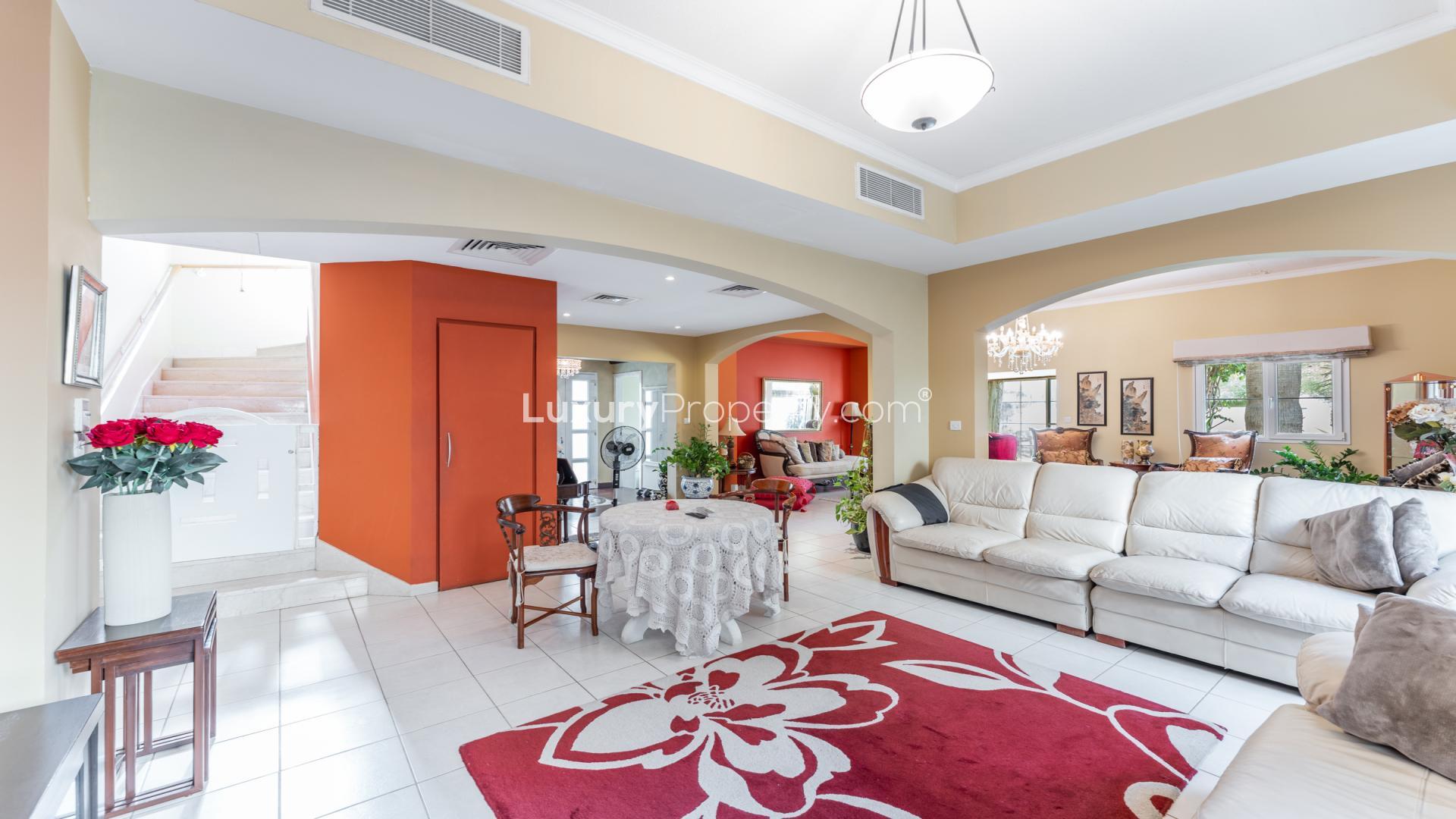 Spacious living room in upgraded Meadows 1 villa, featuring elegant decor and natural light
