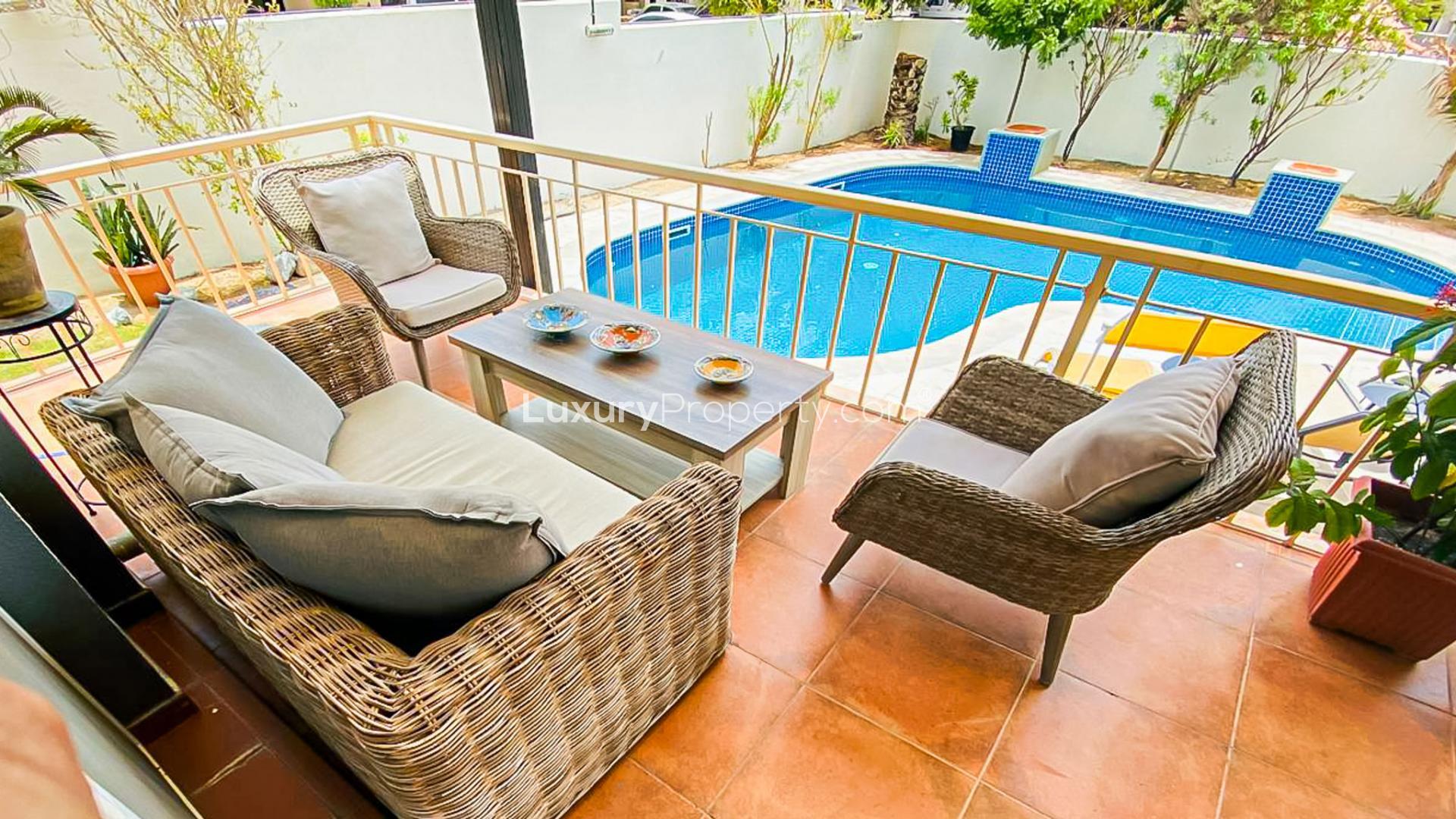 Outdoor pool with sun loungers at luxury villa for rent in Springs 14 community