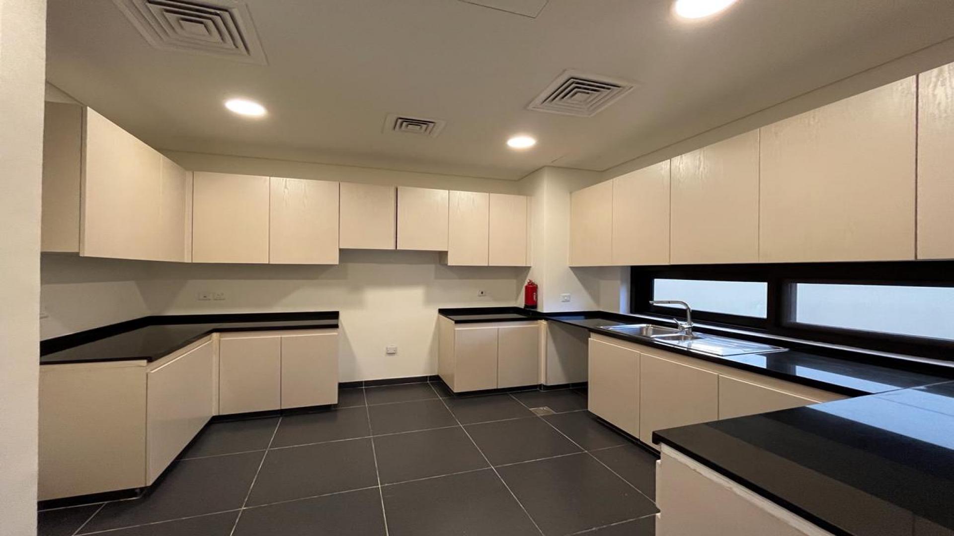 Spacious living room with large windows in Damac Hills villa, Richmond community