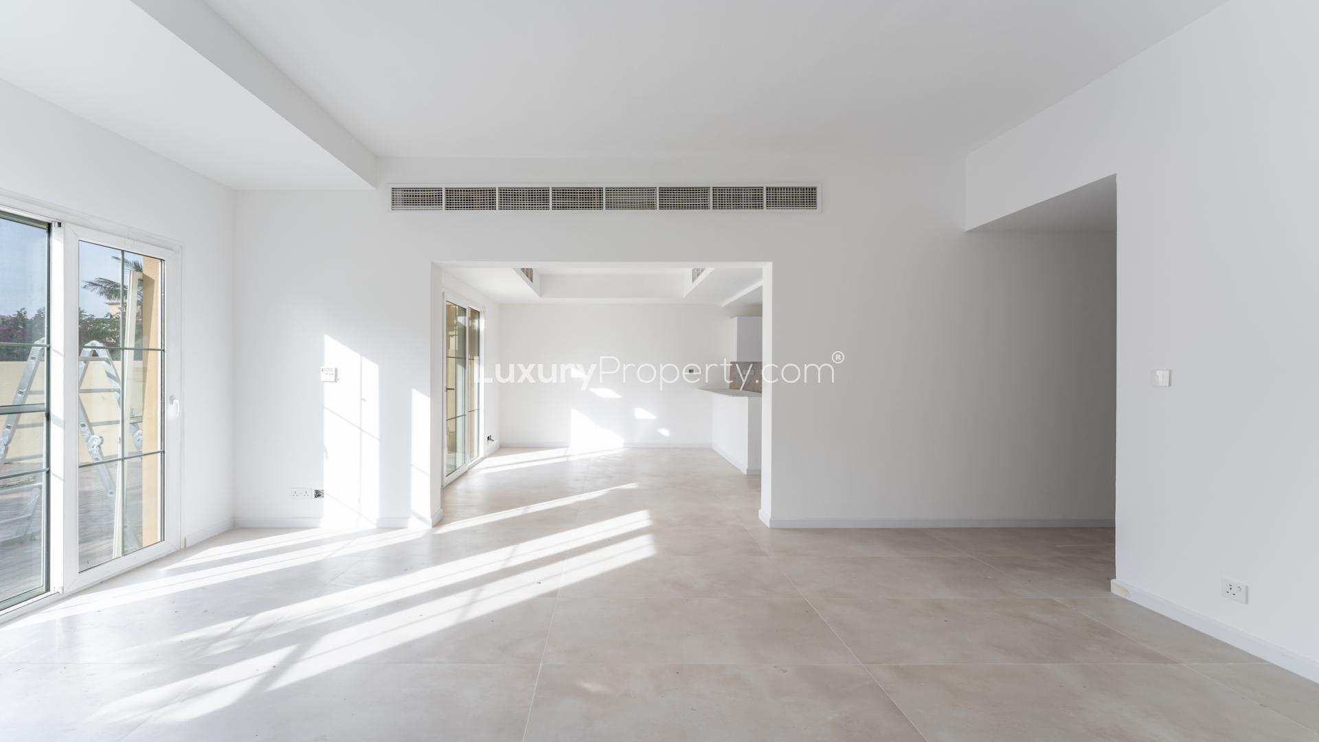 "Bright living area in renovated villa, Springs 14, with large windows and patio view.",Bright spacious living area in renovated villa, Springs 14, ready to move in