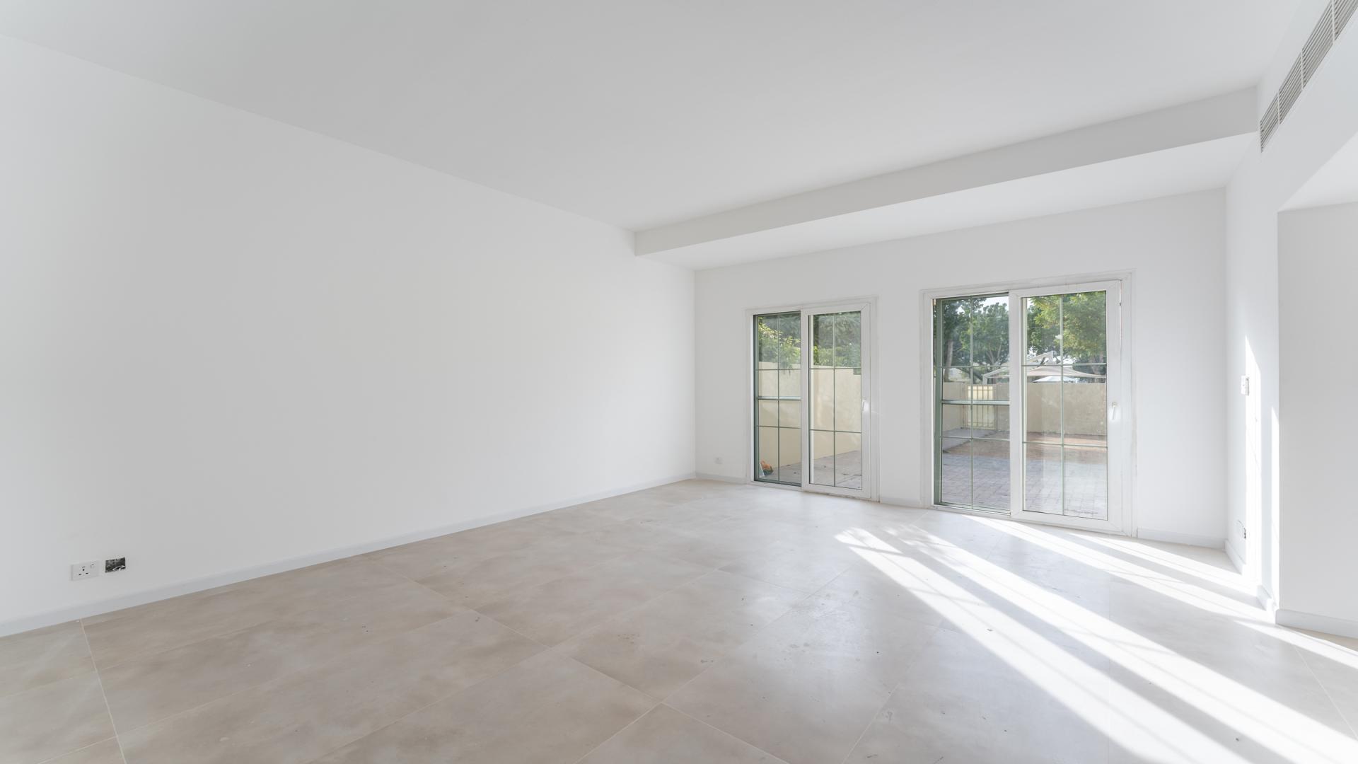 Spacious living room in upgraded villa, Springs 14, featuring large windows and bright interiors
