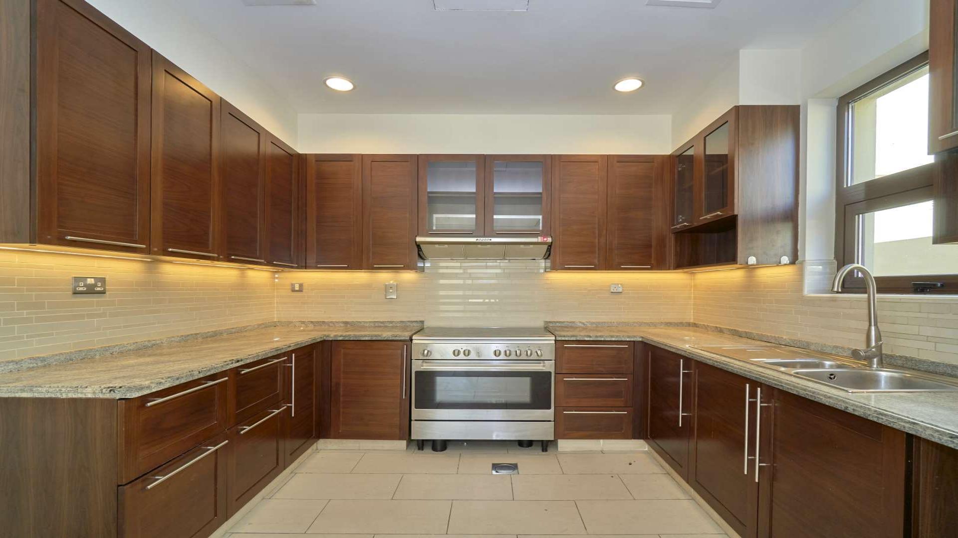 "Bright living area with staircase in Casa, Arabian Ranches 2 villa for rent.",Modern kitchen with wooden cabinets in 3-bed villa, Casa, Arabian Ranches 2 for rent