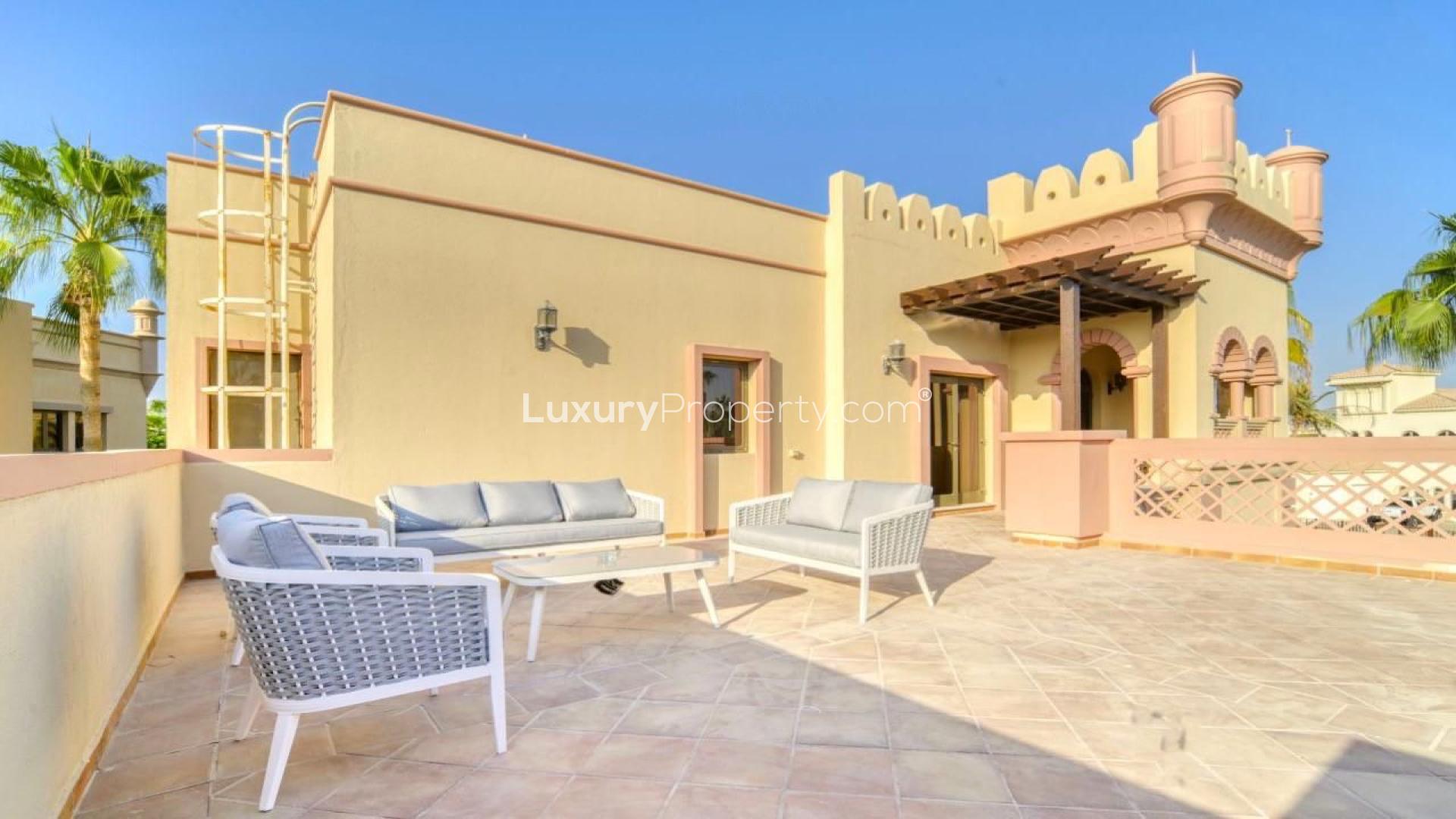 "Bright hallway in Palm Jumeirah Canal Cove Villa with elegant railing and wooden flooring.",Sunny terrace of Canal Cove Villa for rent in Palm Jumeirah, Dubai