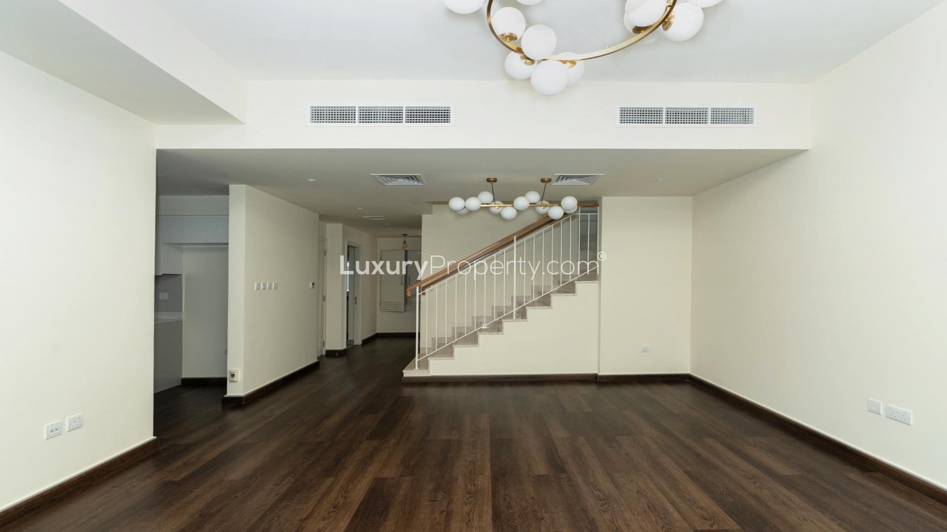 Spacious living room with wooden flooring in Dubai Hills Estate Maple 3 villa for rent