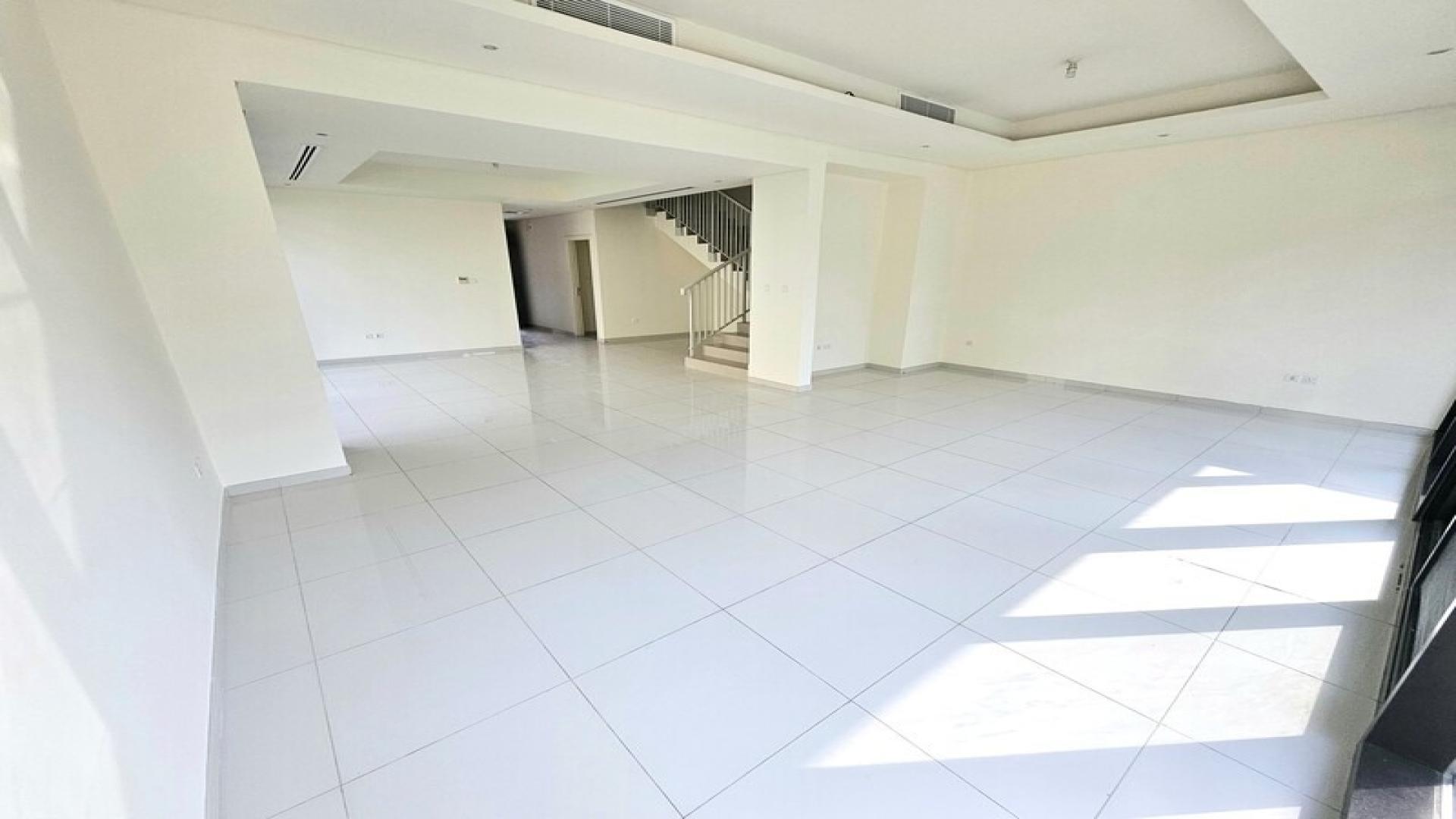 Spacious living area in elegant 3-bedroom villa, Damac Hills, Richmond, with modern staircase