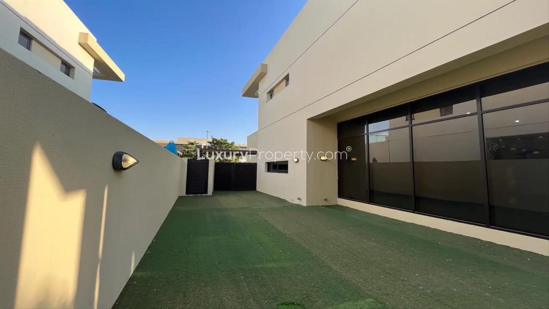 Bright living room with large windows in Damac Hills villa, Richmond sub-community