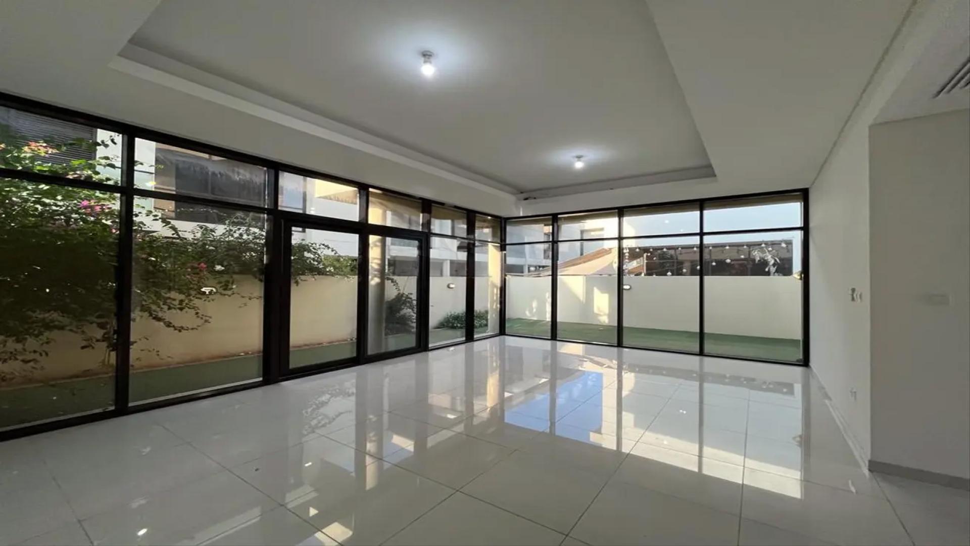 Semi-detached villa backyard with artificial grass in Richmond, Damac Hills