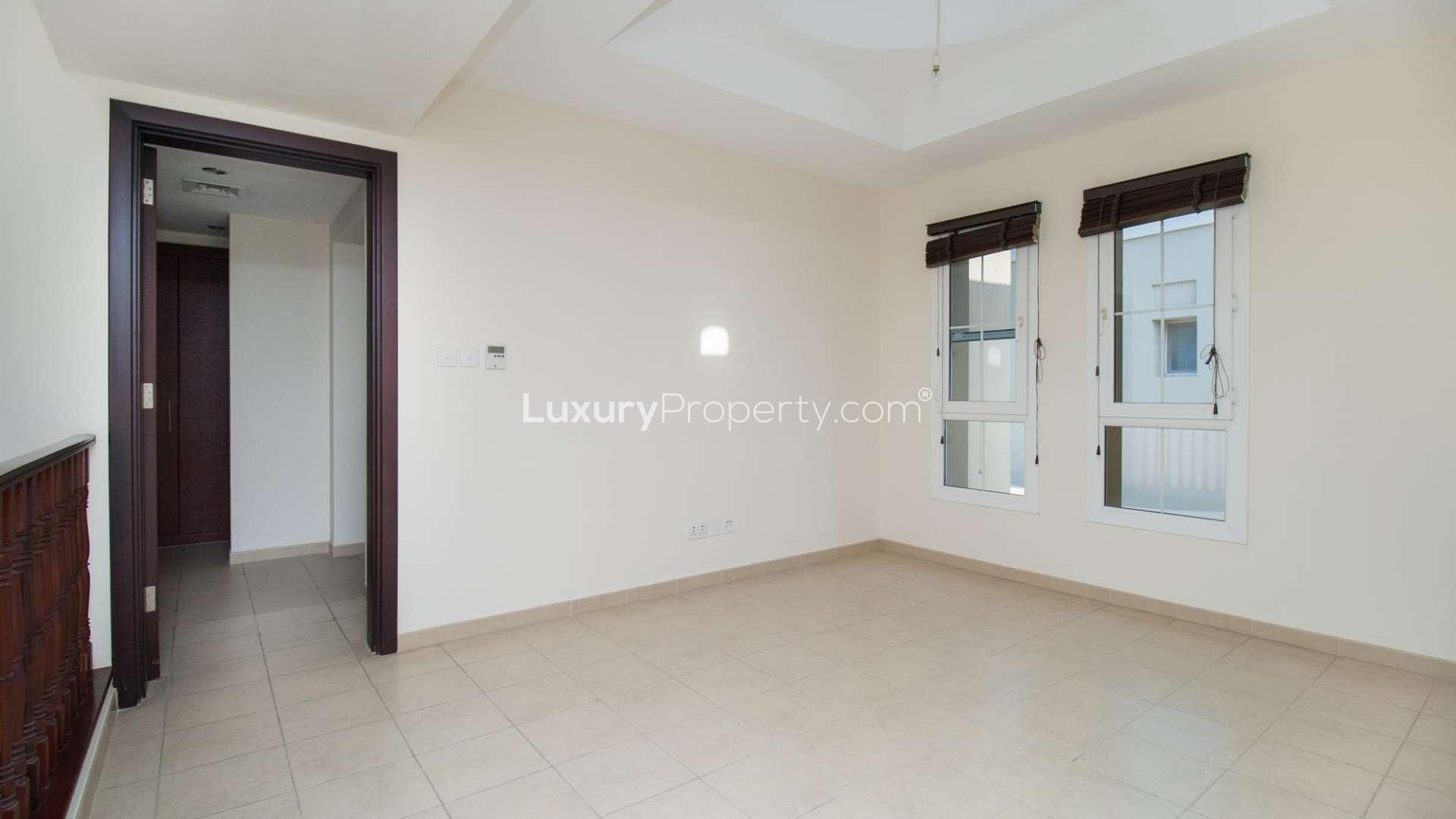 "Scenic view from 3-bedroom townhouse in Al Reem, Arabian Ranches, lush greenery and pathway.","Bright room with windows in 3-bedroom townhouse, Al Reem, Arabian Ranches, for rent.",Spacious living area in 3-bedroom townhouse, Al Reem, Arabian Ranches, available for rent