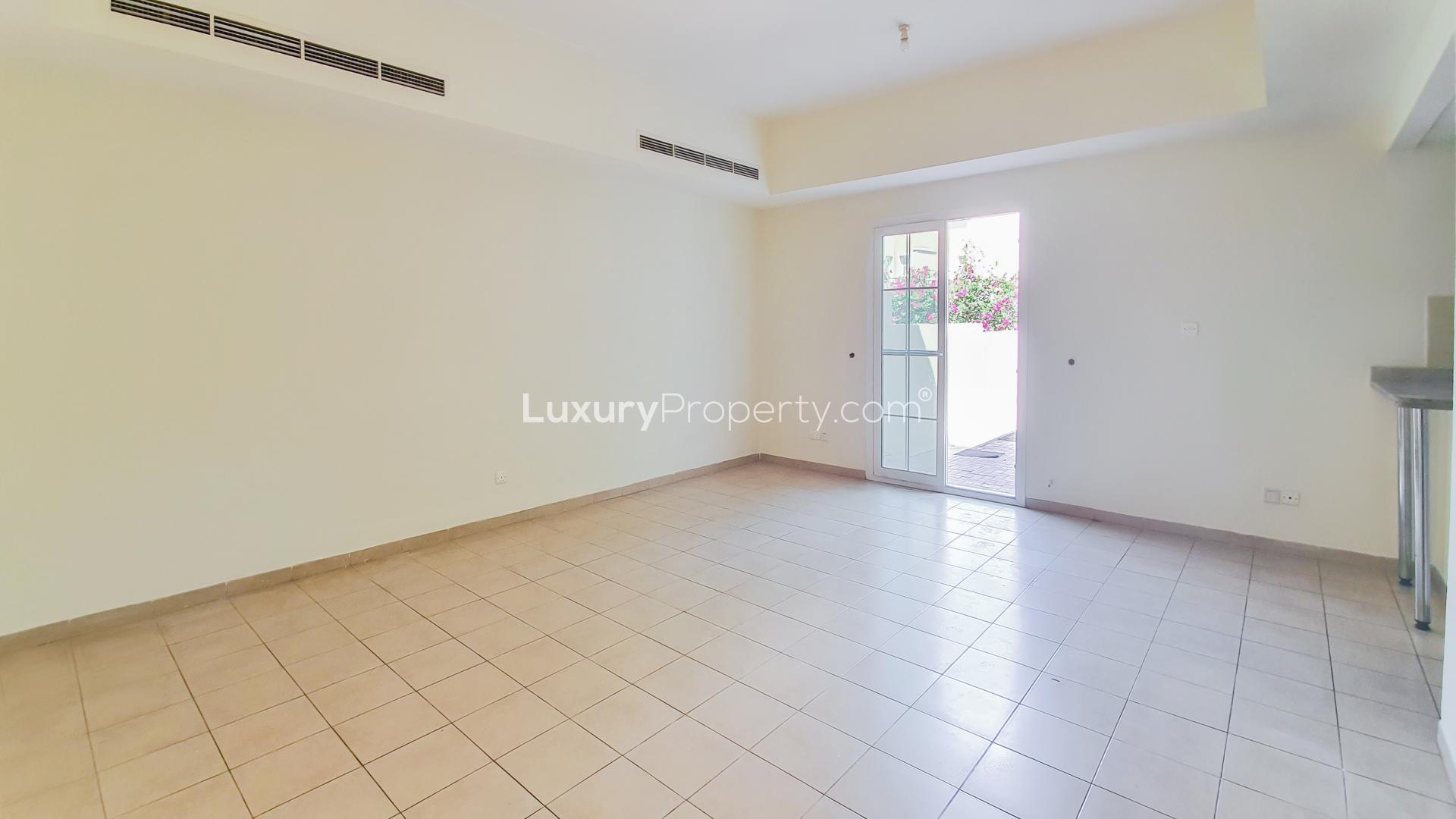 N/A,Empty living room in 3-bedroom townhouse, Al Reem, Arabian Ranches, with tiled floor and patio door