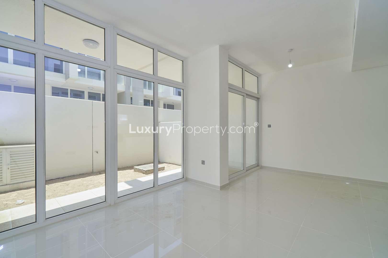 Three-bedroom townhouse exterior in Albizia, Damac Hills 2, with garage and modern design