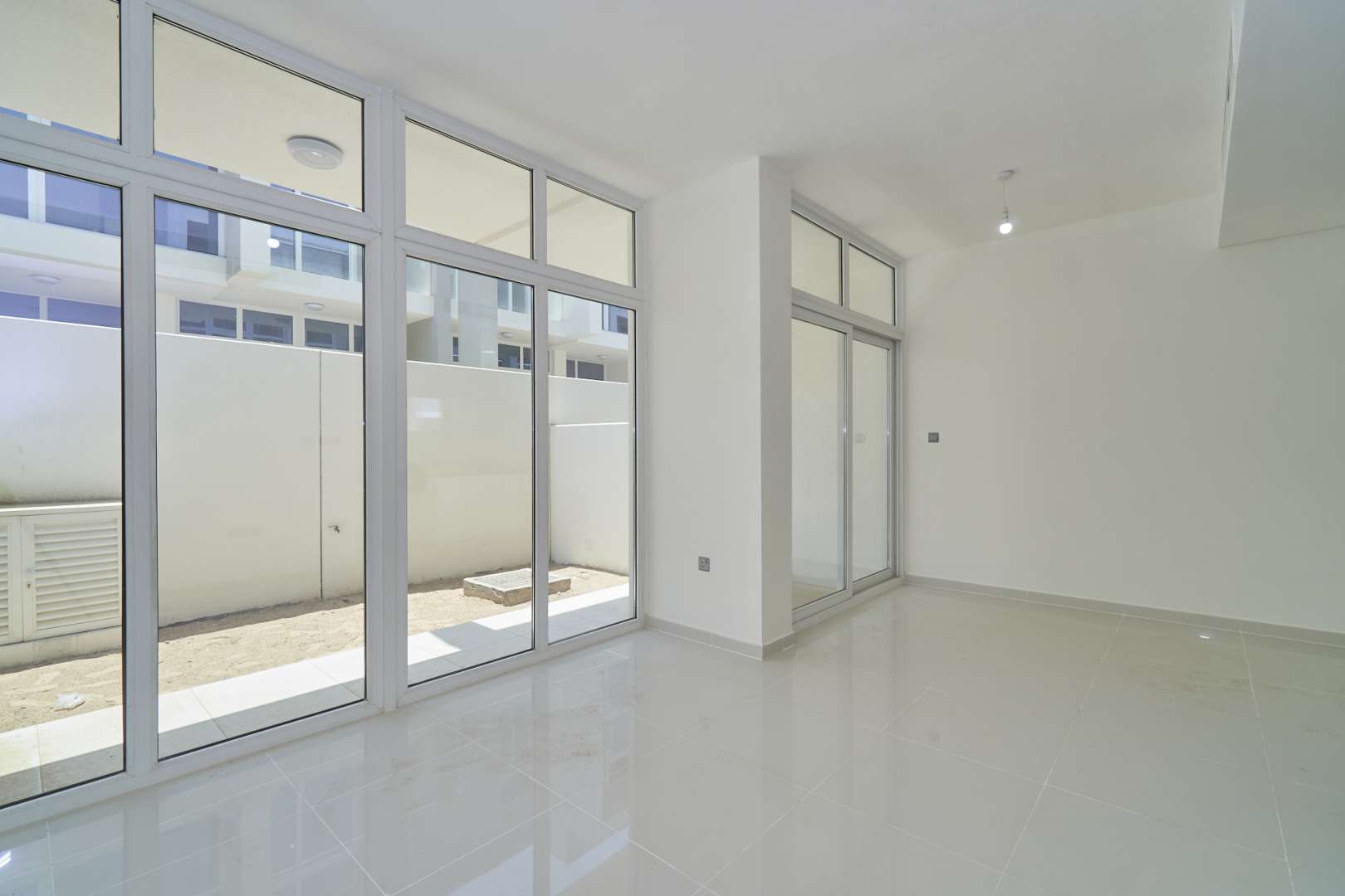 Three-bedroom townhouse exterior in Albizia, Damac Hills 2, with garage and modern design