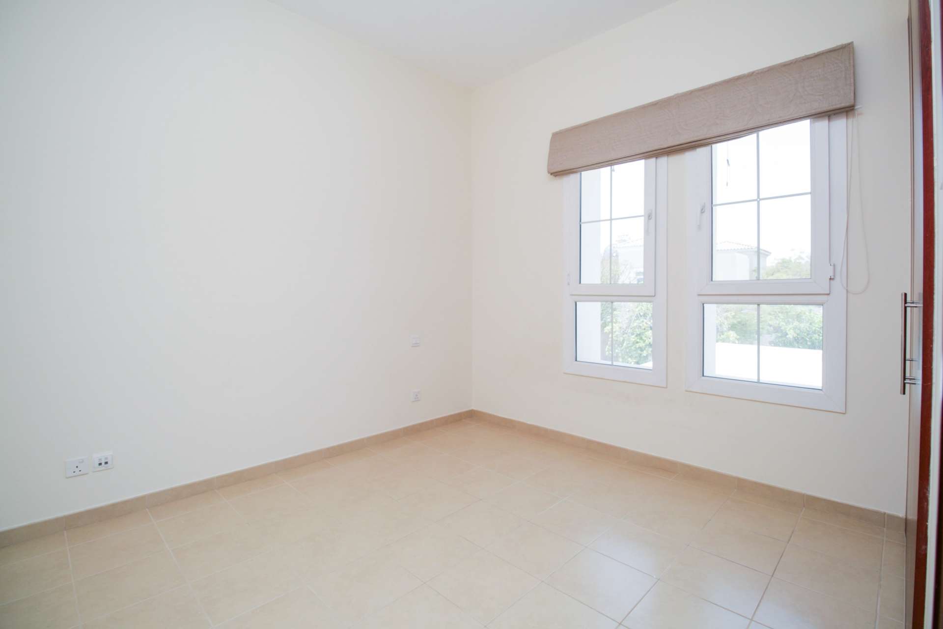 Hallway with wooden doors and staircase in Alma 1 villa, Arabian Ranches for rent