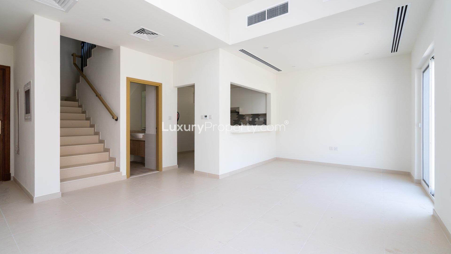 Bright living area with sliding glass doors in Amaranta Villanova townhouse for rent