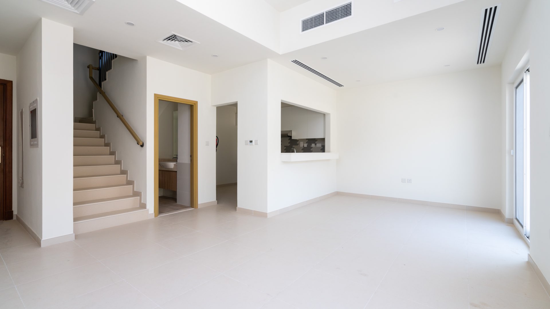 Bright living area with sliding glass doors in Amaranta Villanova townhouse for rent