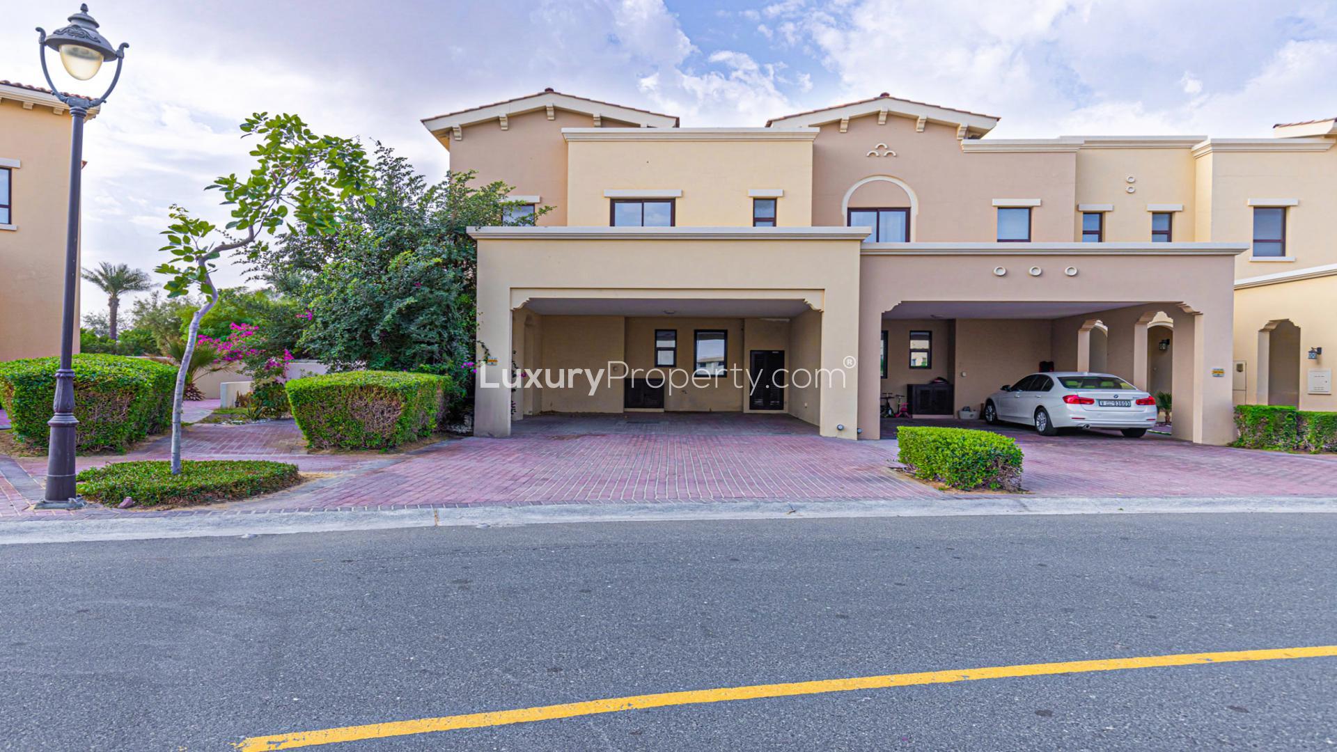 Empty living room in 3-bed villa, Mira, Reem community, with tiled flooring and kitchen view